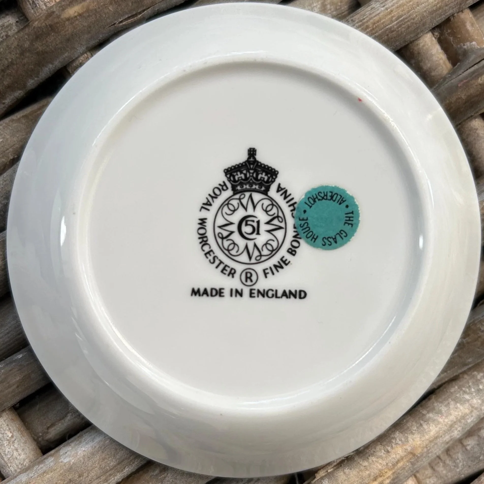 Underside view of pink dish with inspection sticker still attached