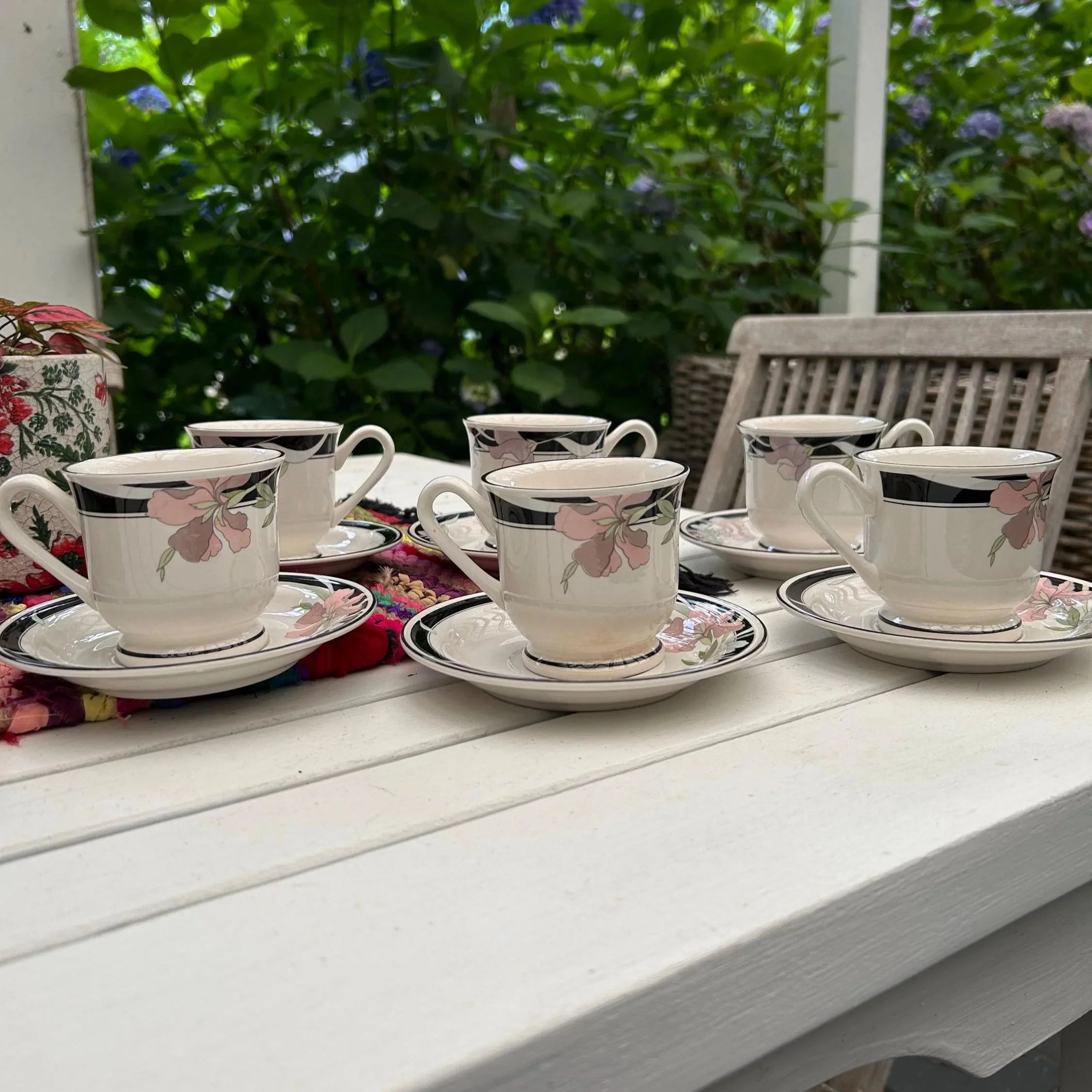 Full 6-piece duo set of Sangostone cups and saucers on a white outdoor table