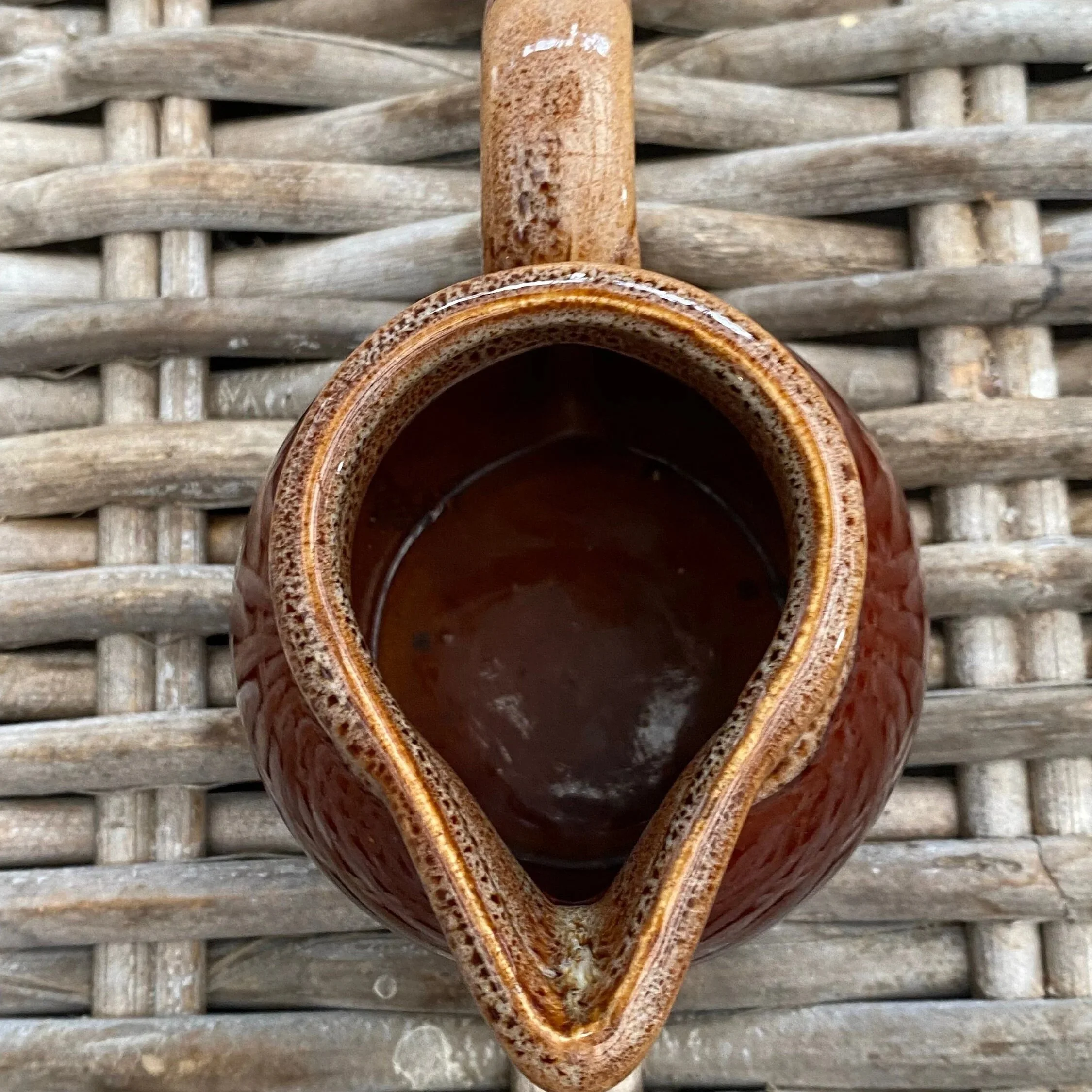 Overhead view of creamer showing clean spout and glossy interior