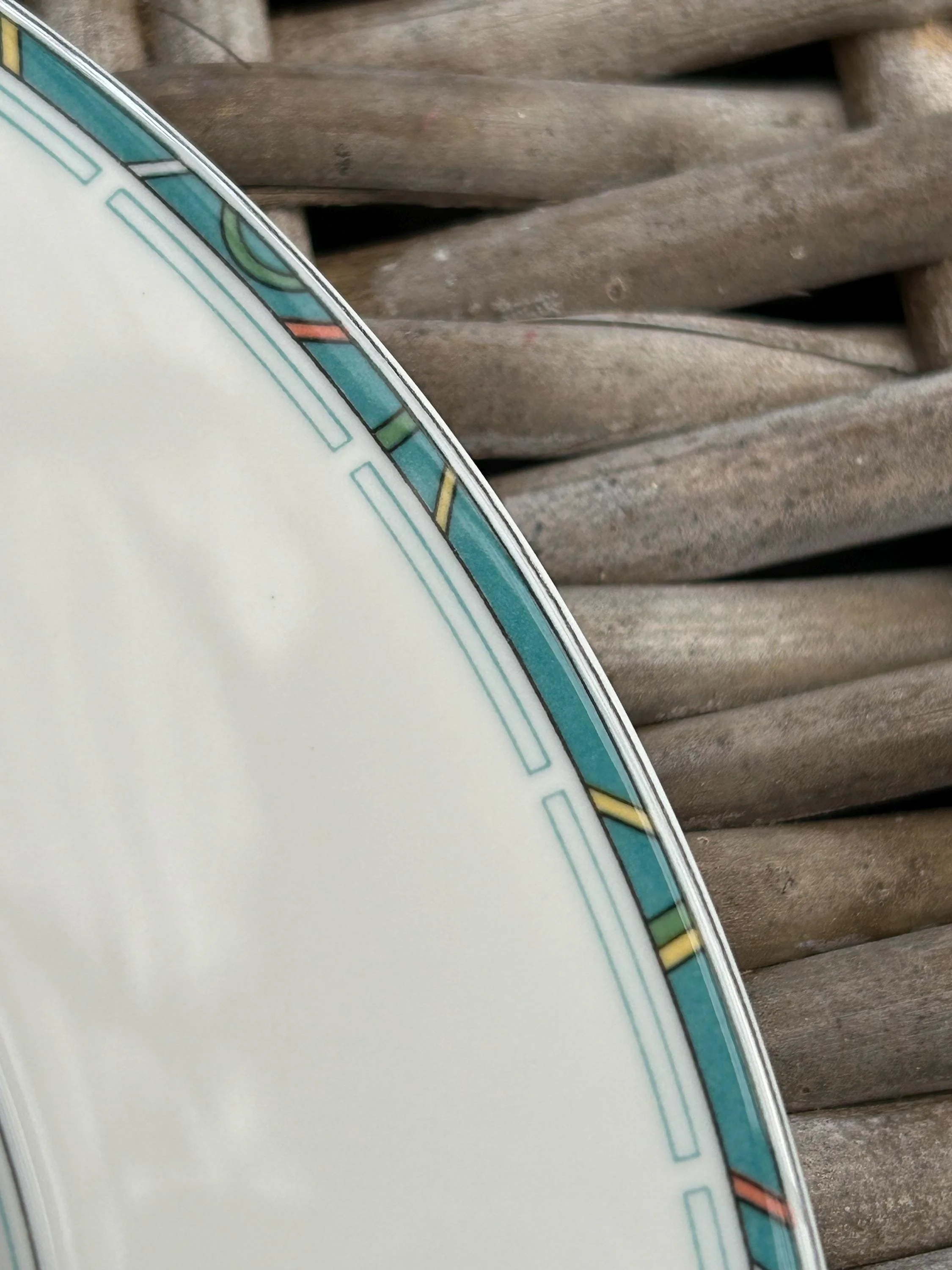 Macro of Art Deco rim pattern with teal and coral blocks