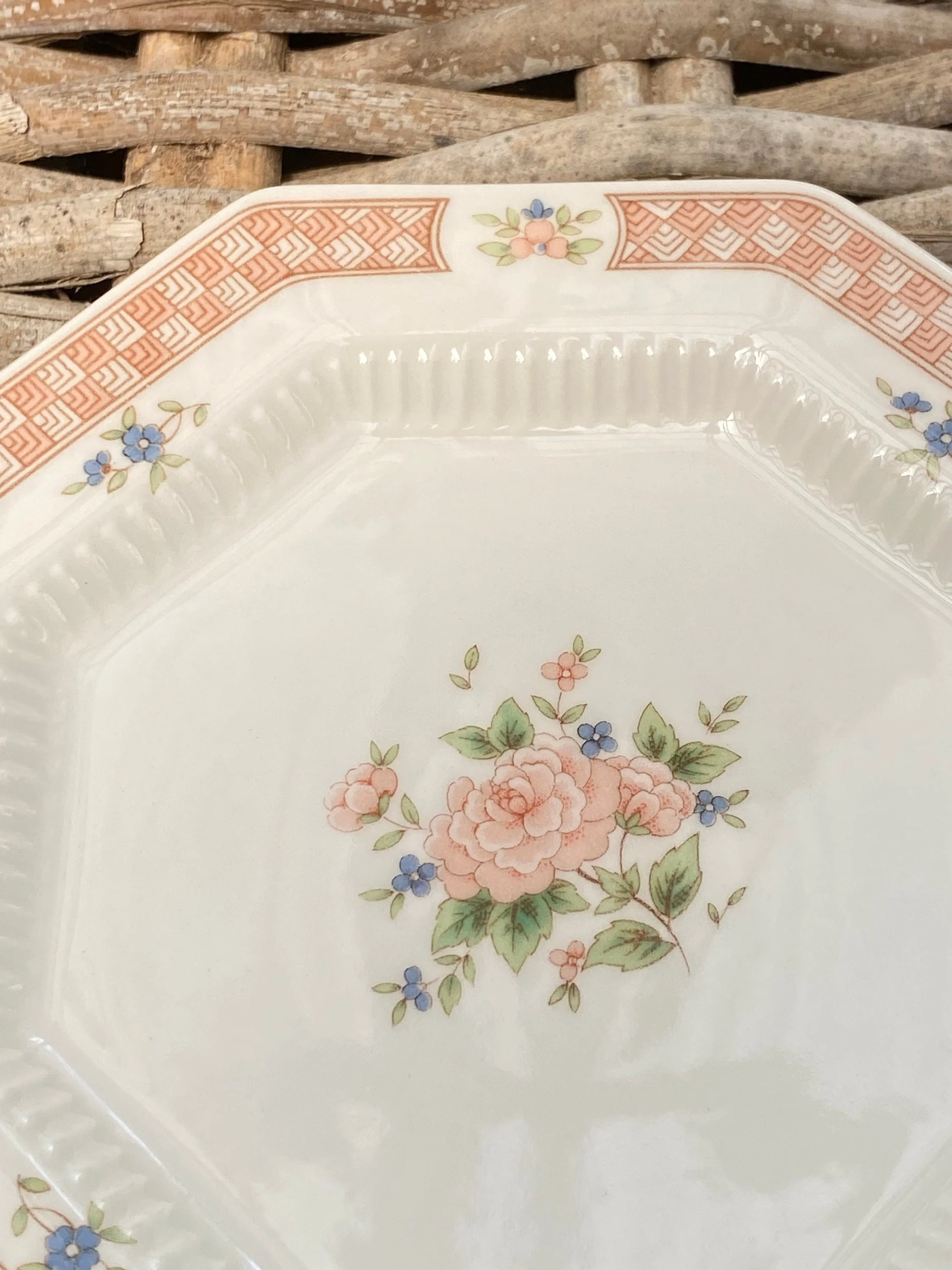 Close-up of floral motif and pink geometric border pattern