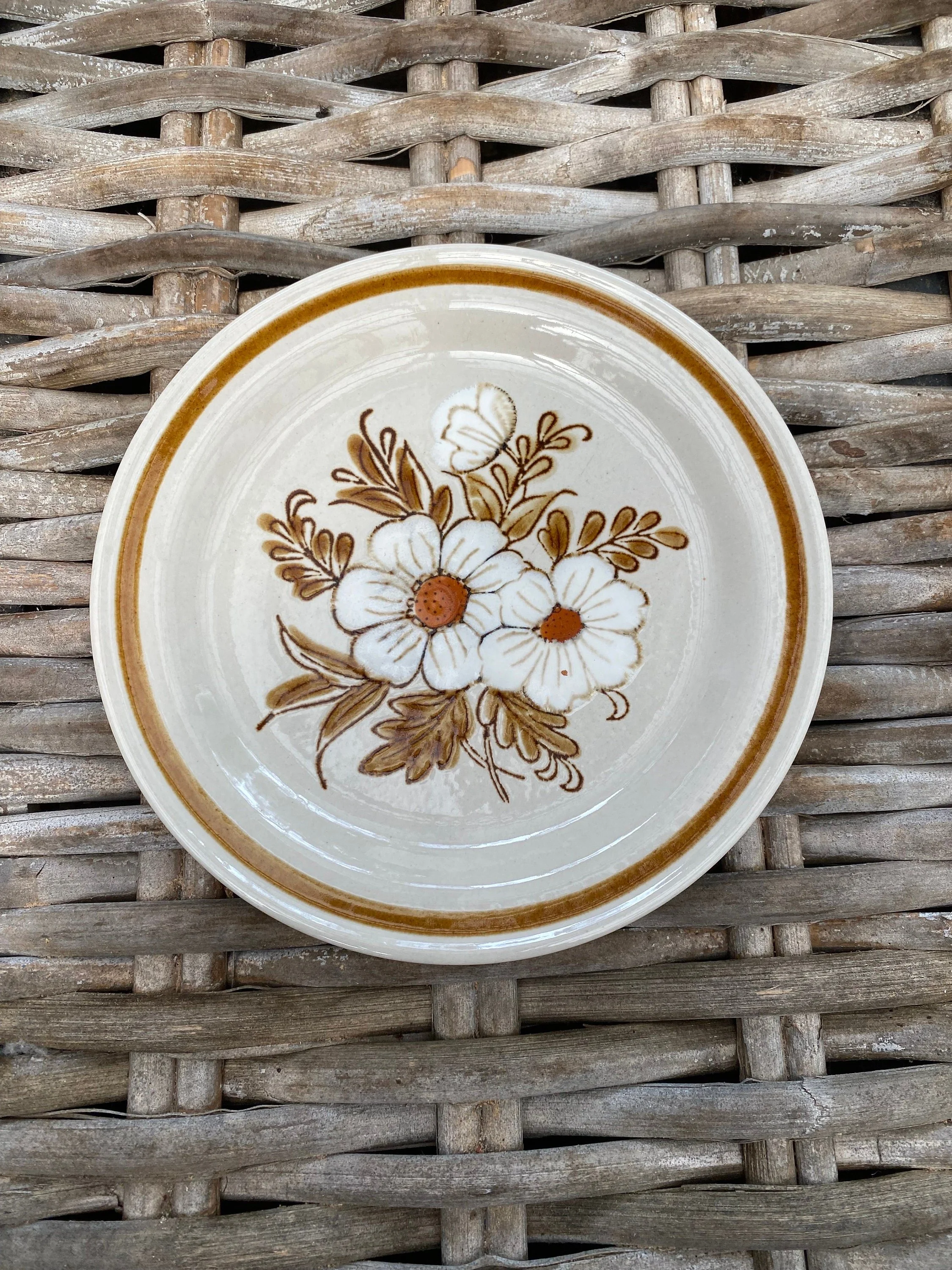 Close-up of side plate featuring dried flower motif