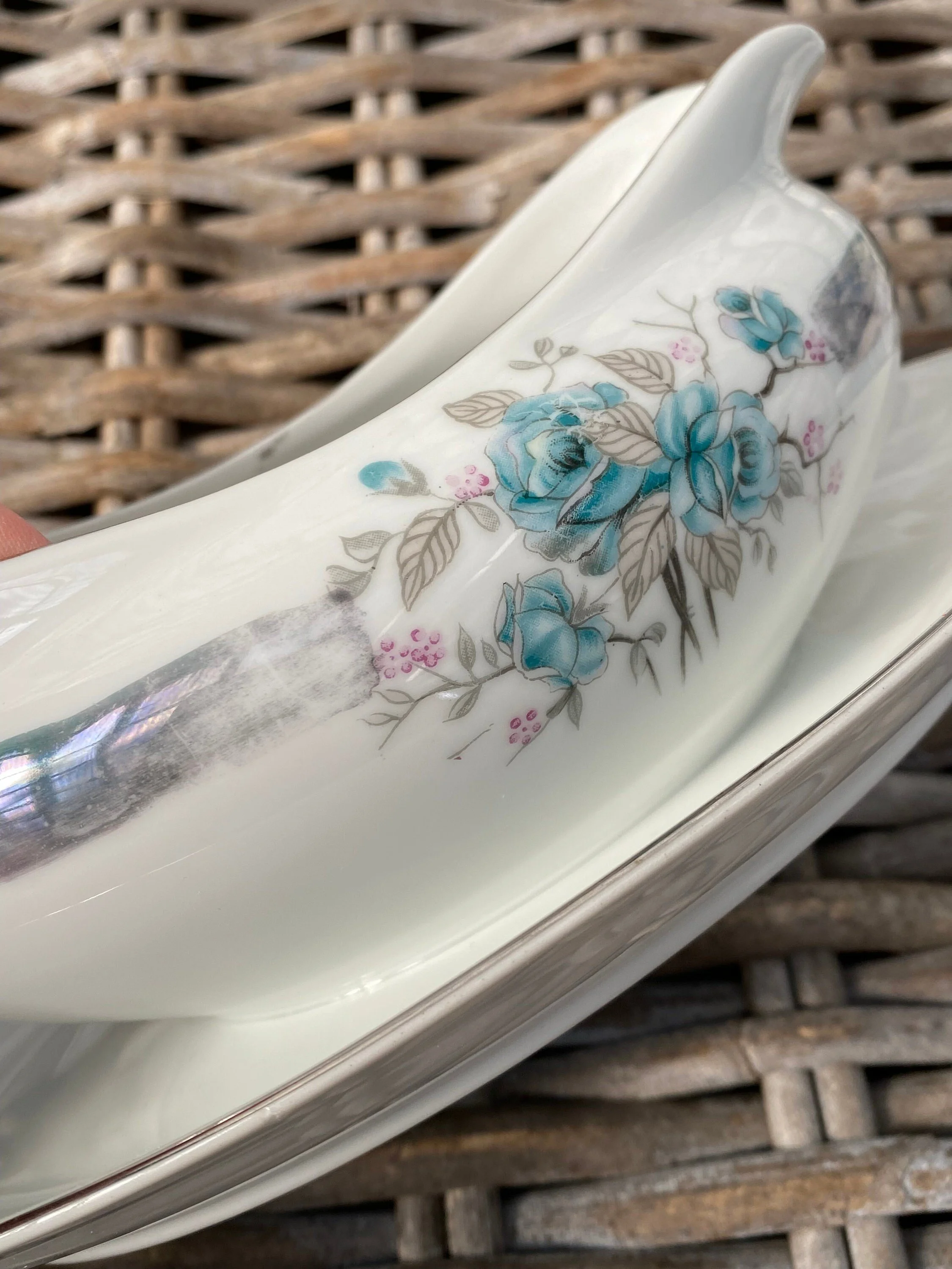 Side detail of gravy boat with blue floral pattern