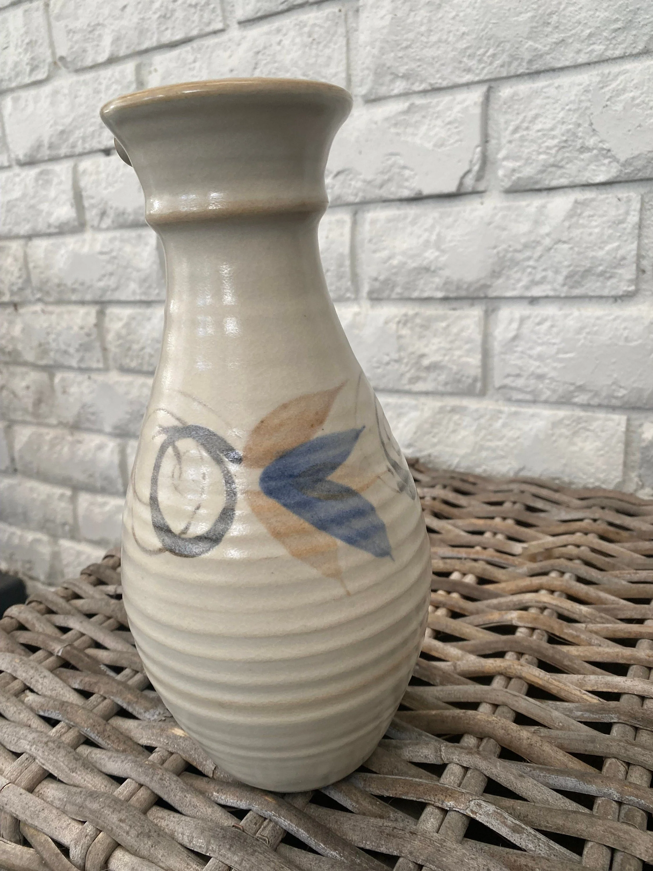 Full back view showing cream glaze and circular motif