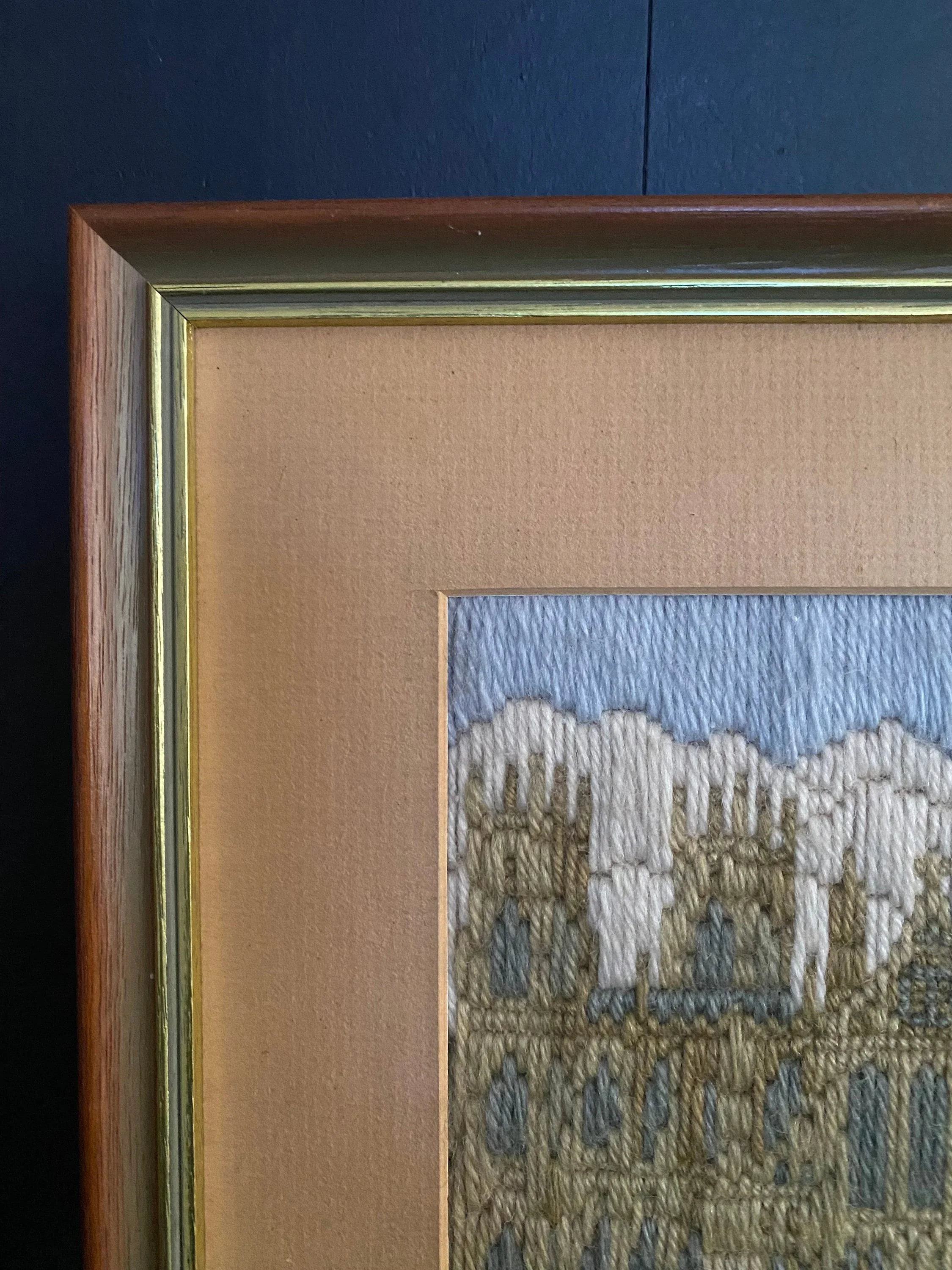 Close-up of the upper left section of the frame and matting around the long stitch artwork