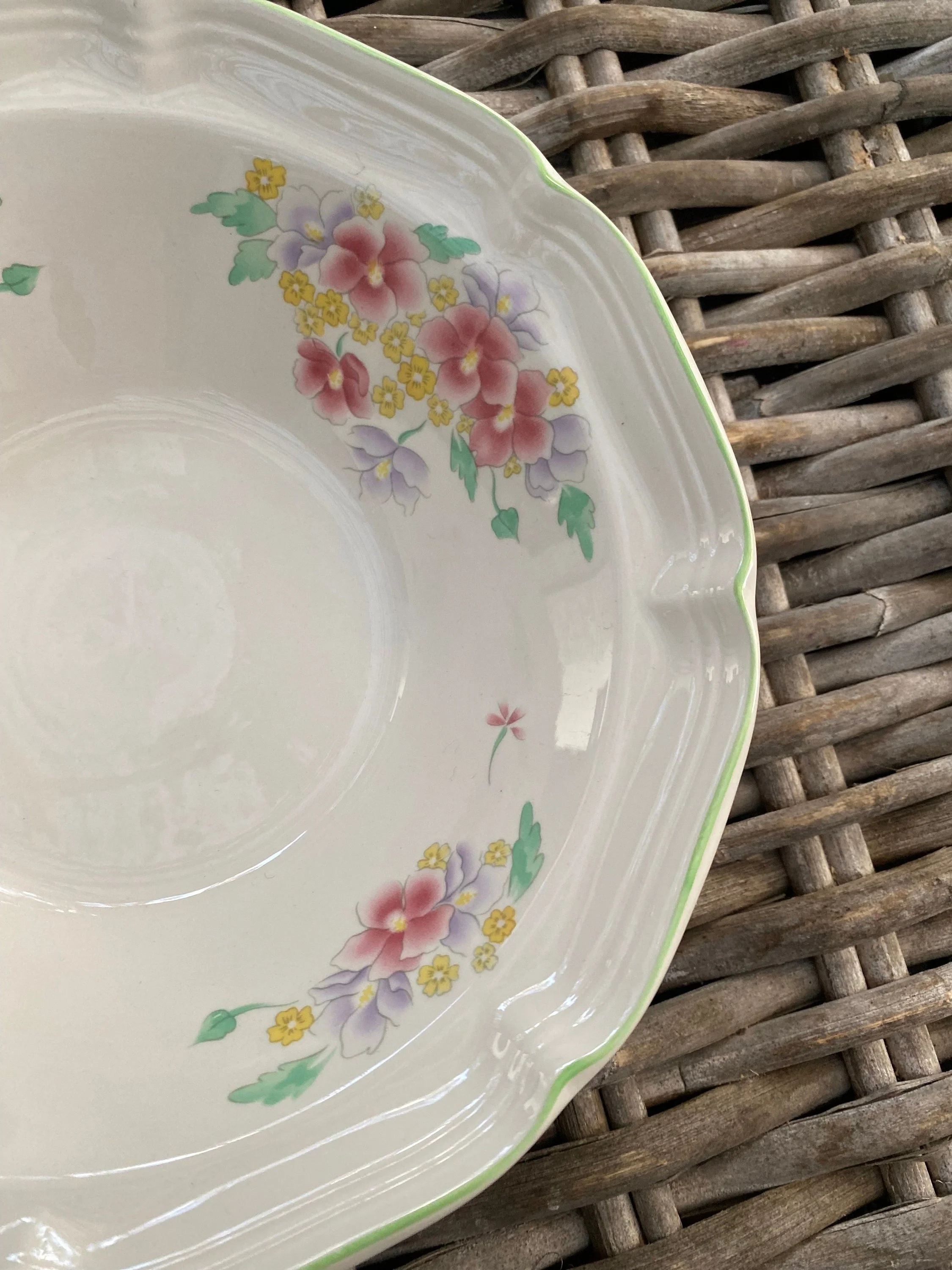 Detail of inner bowl showing pink and yellow floral clusters