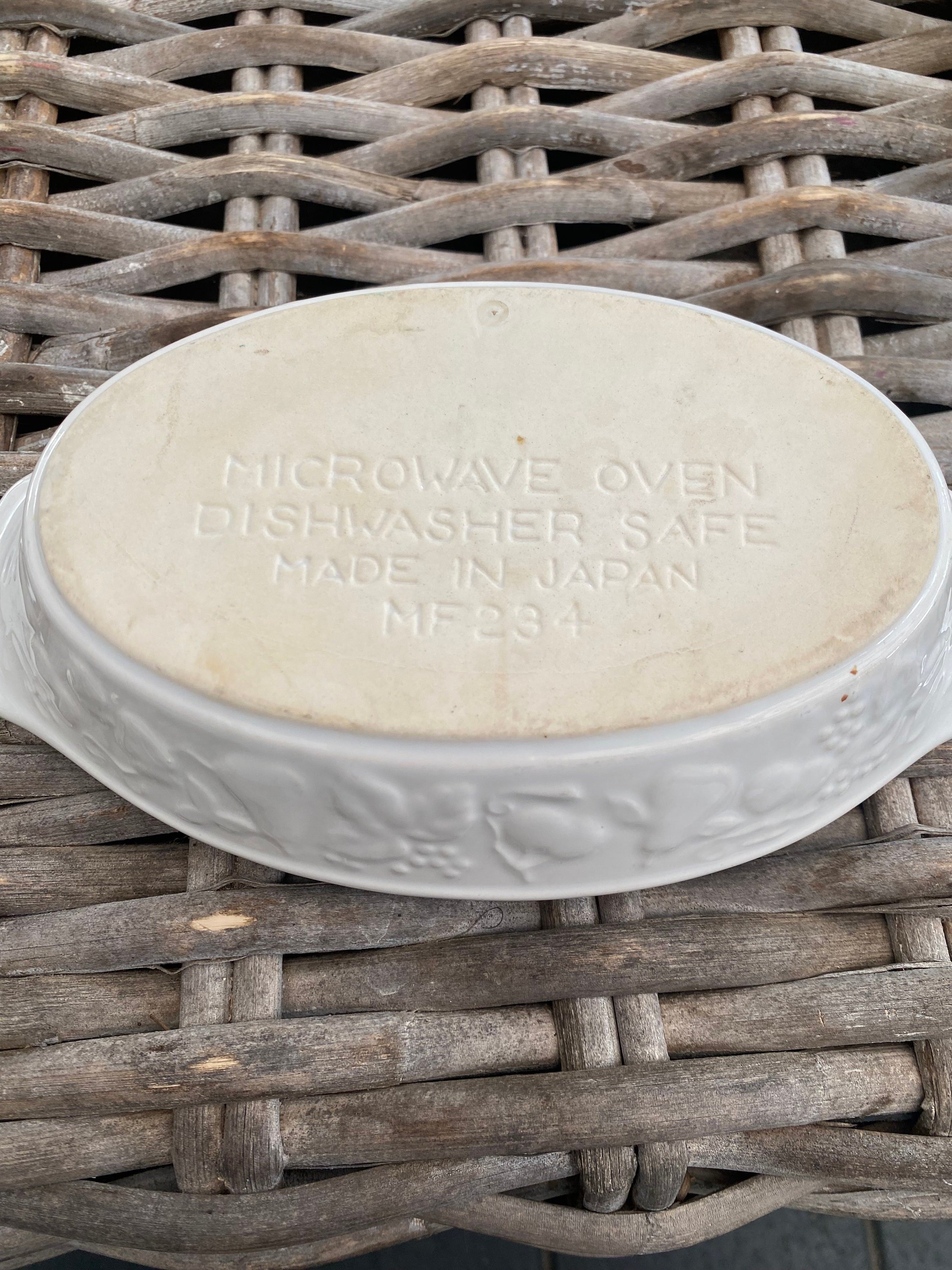 Base of oval baking dish showing microwave and dishwasher safe stamp