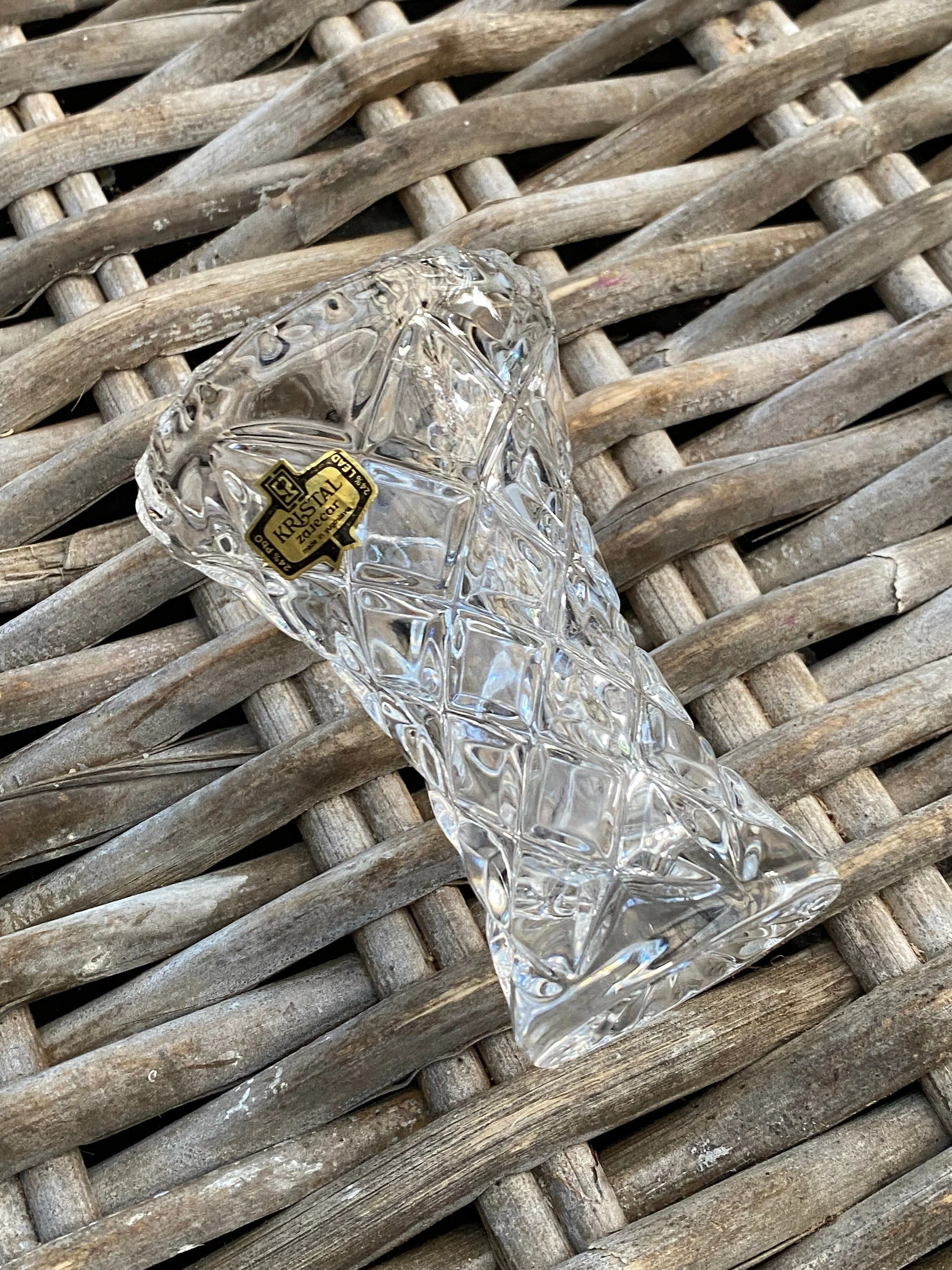 Side profile of the vase lying on its side, showing the full shape and original label