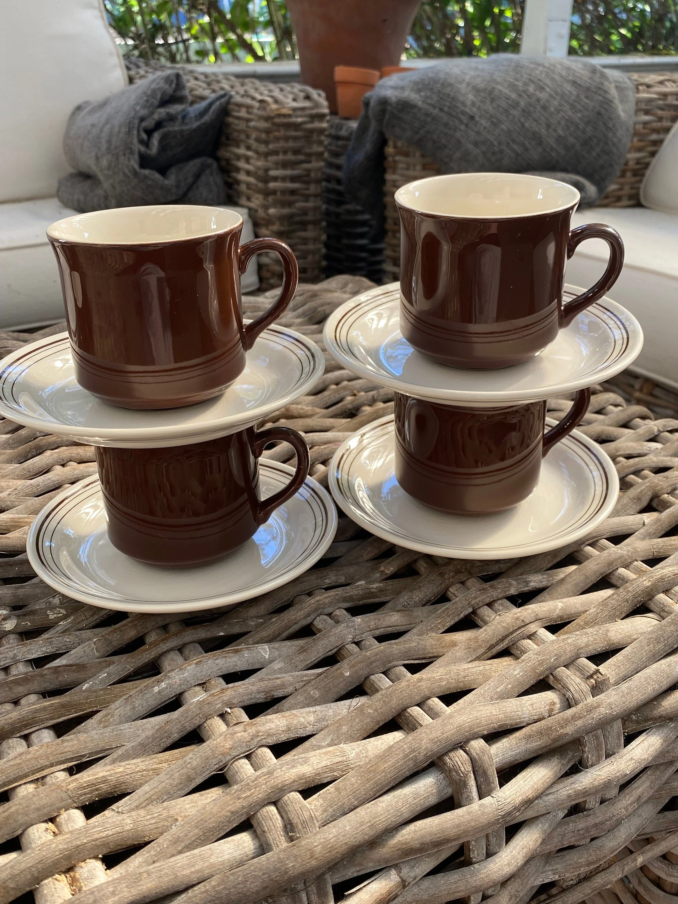 Stacked cups and saucers showing matching glaze and retro shape