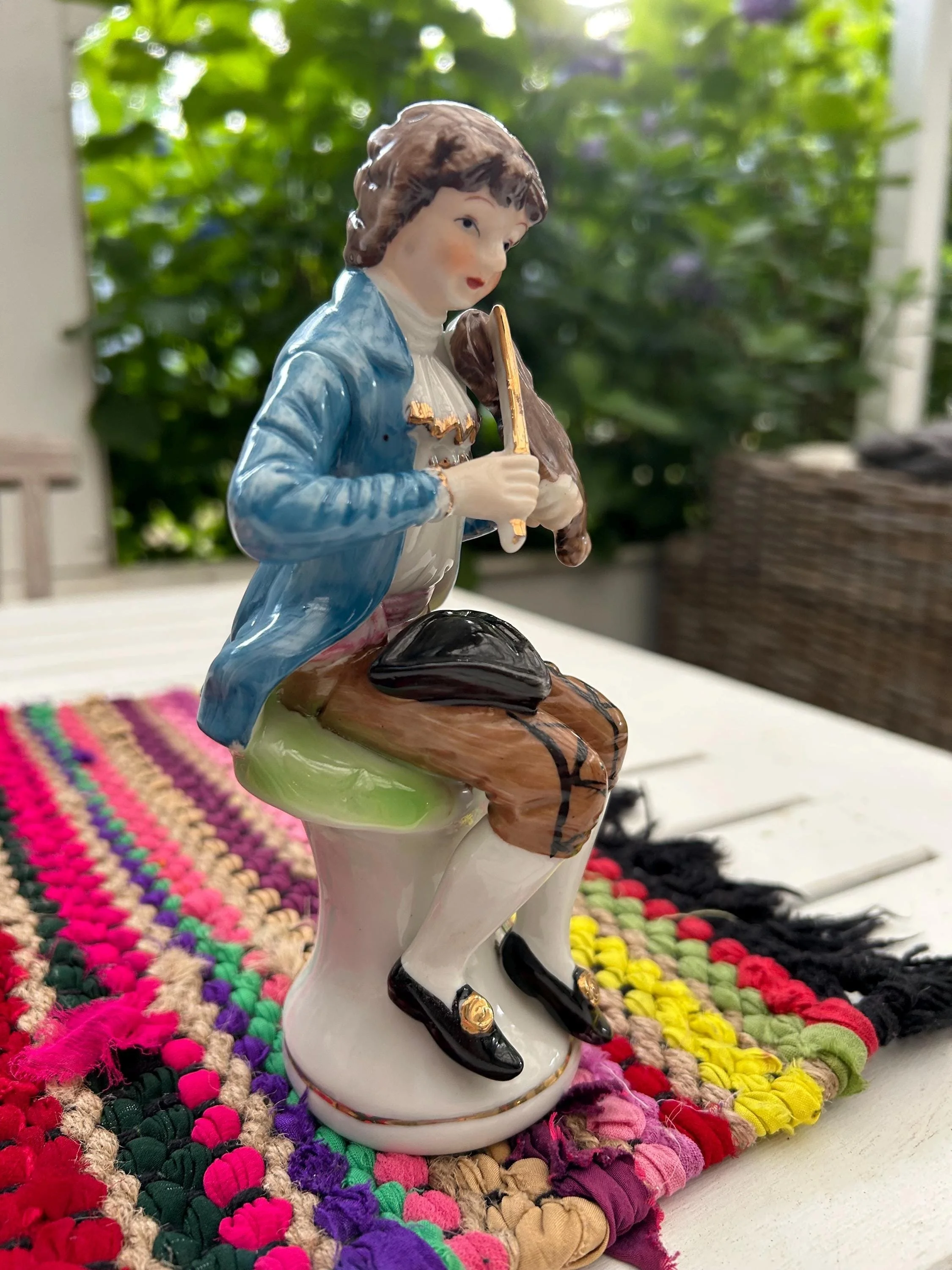 Right side angle of violinist showing hand-painted bow and violin details