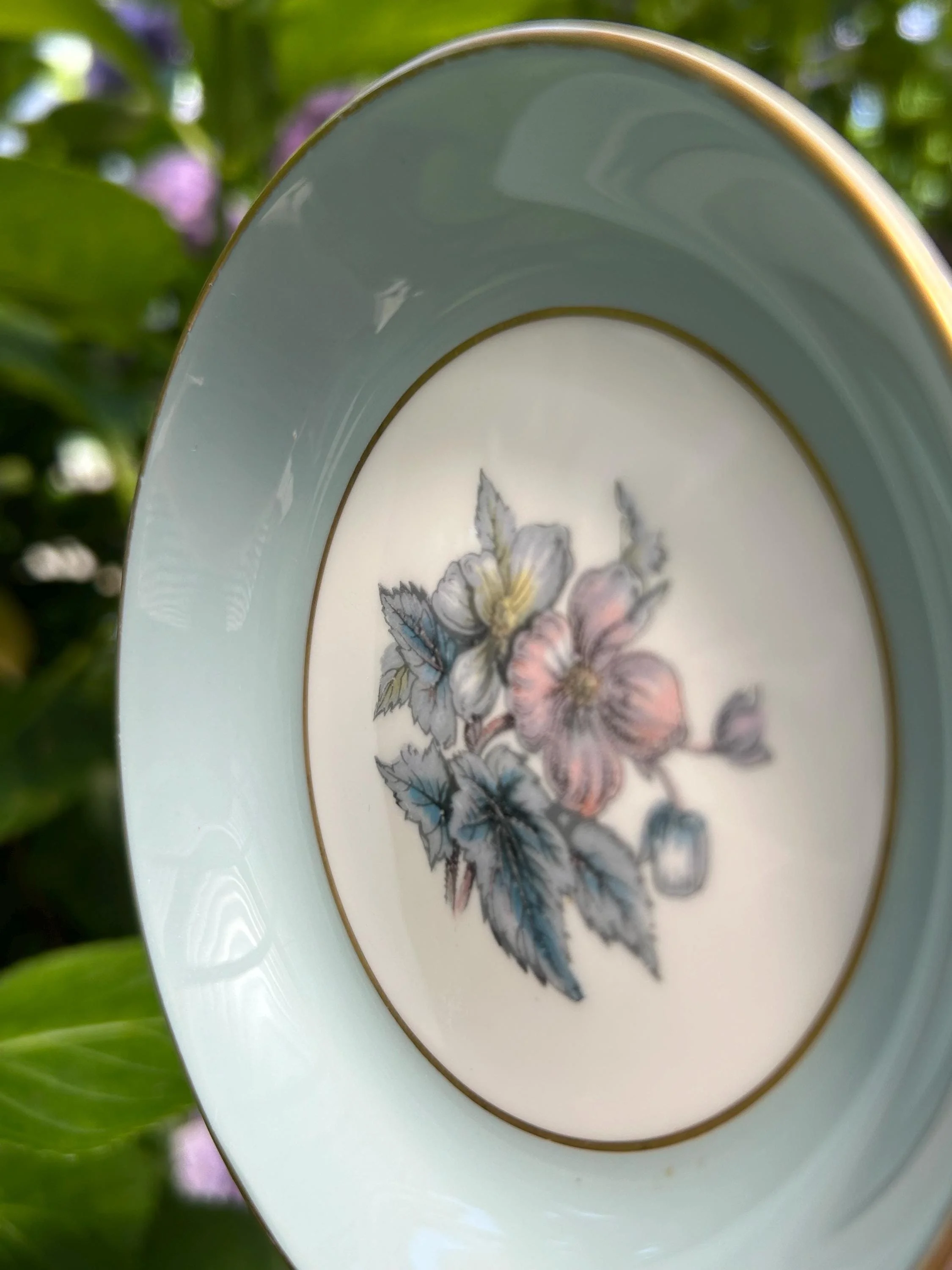 Angled view showing detail of flowers and clean gold rim