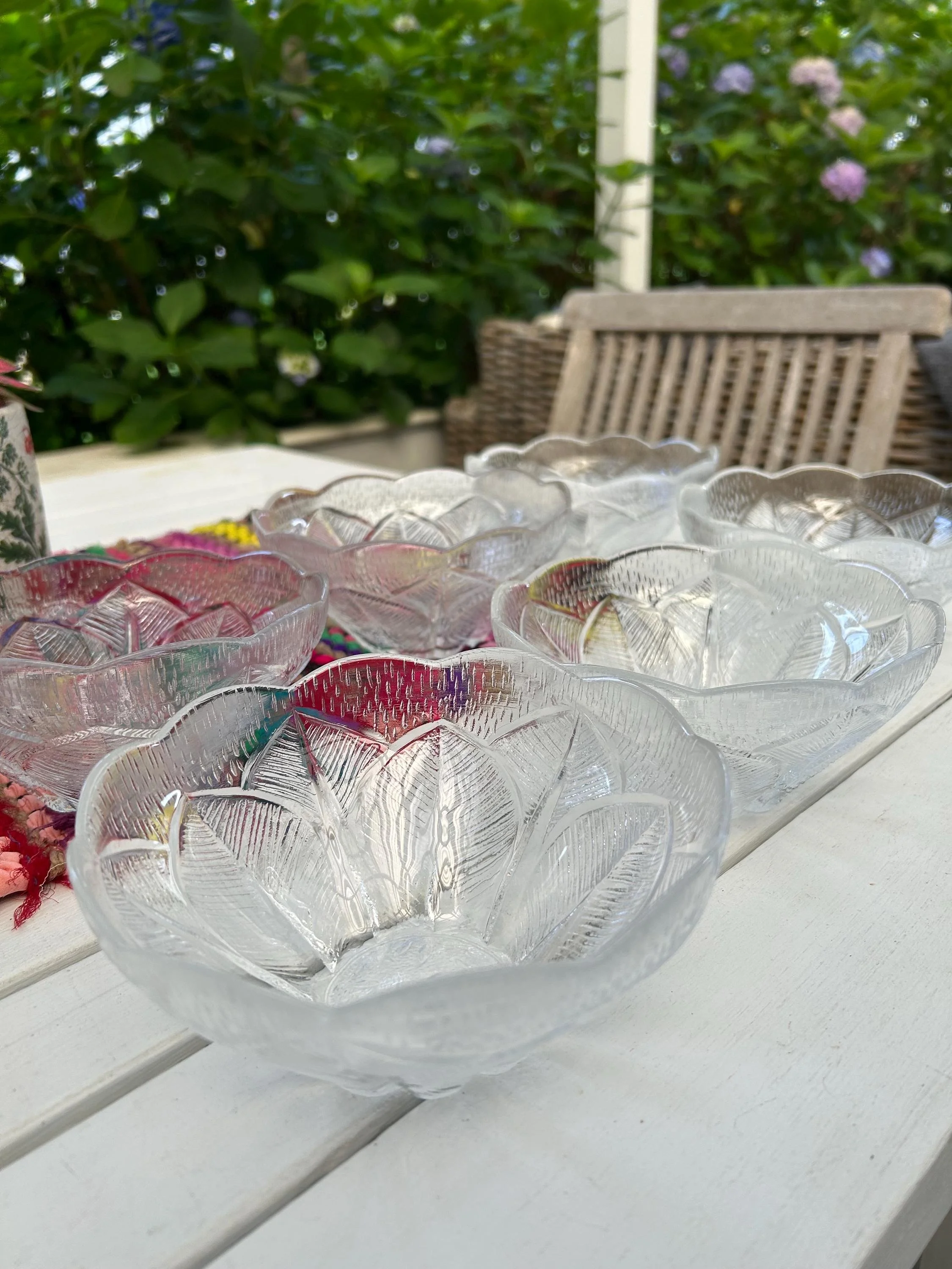 Set of vintage Violetta lead crystal bowls arranged together on a table, showing their scalloped floral shape