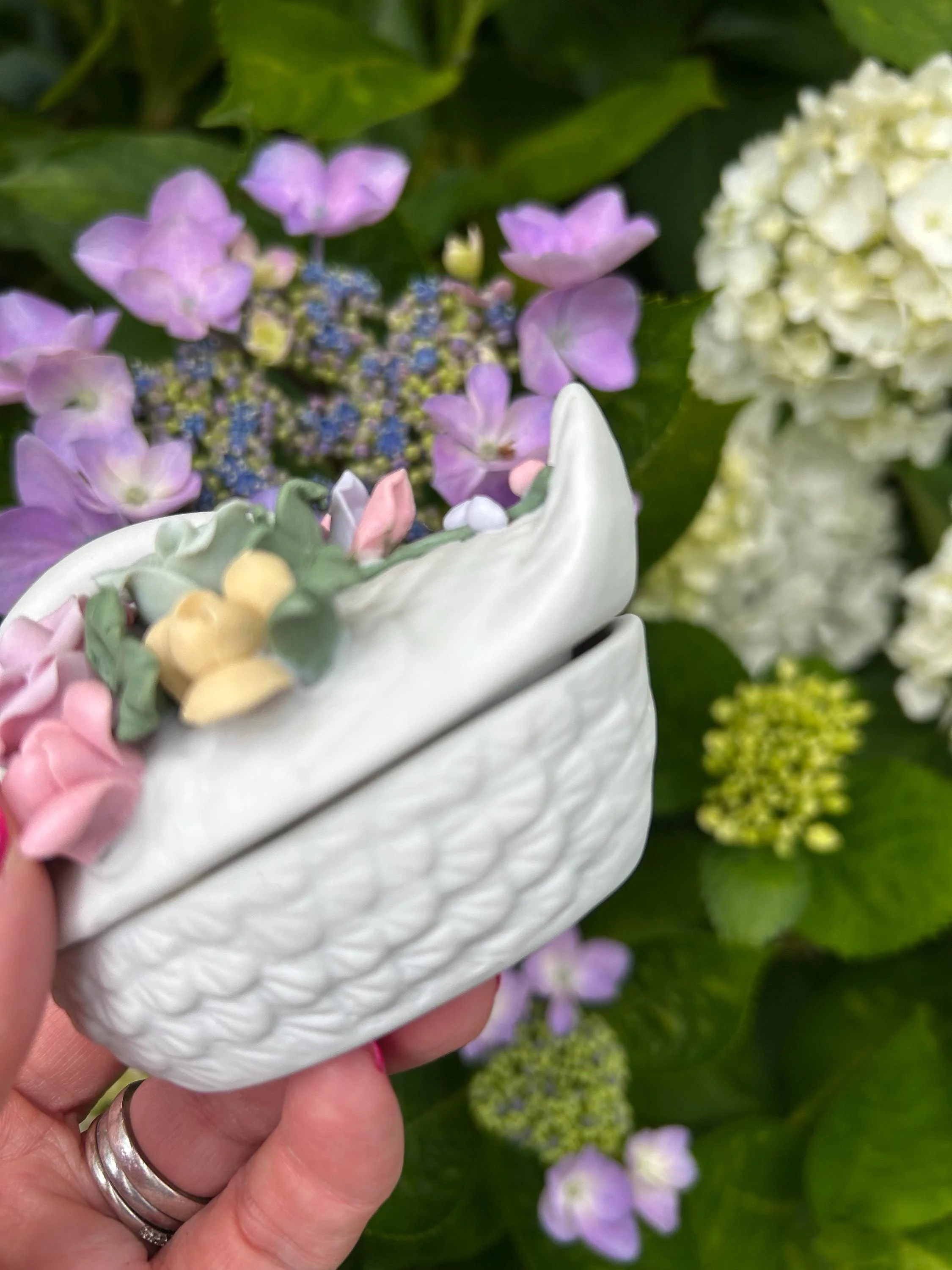 Close-up of pink, yellow, and green flowers on swan's back