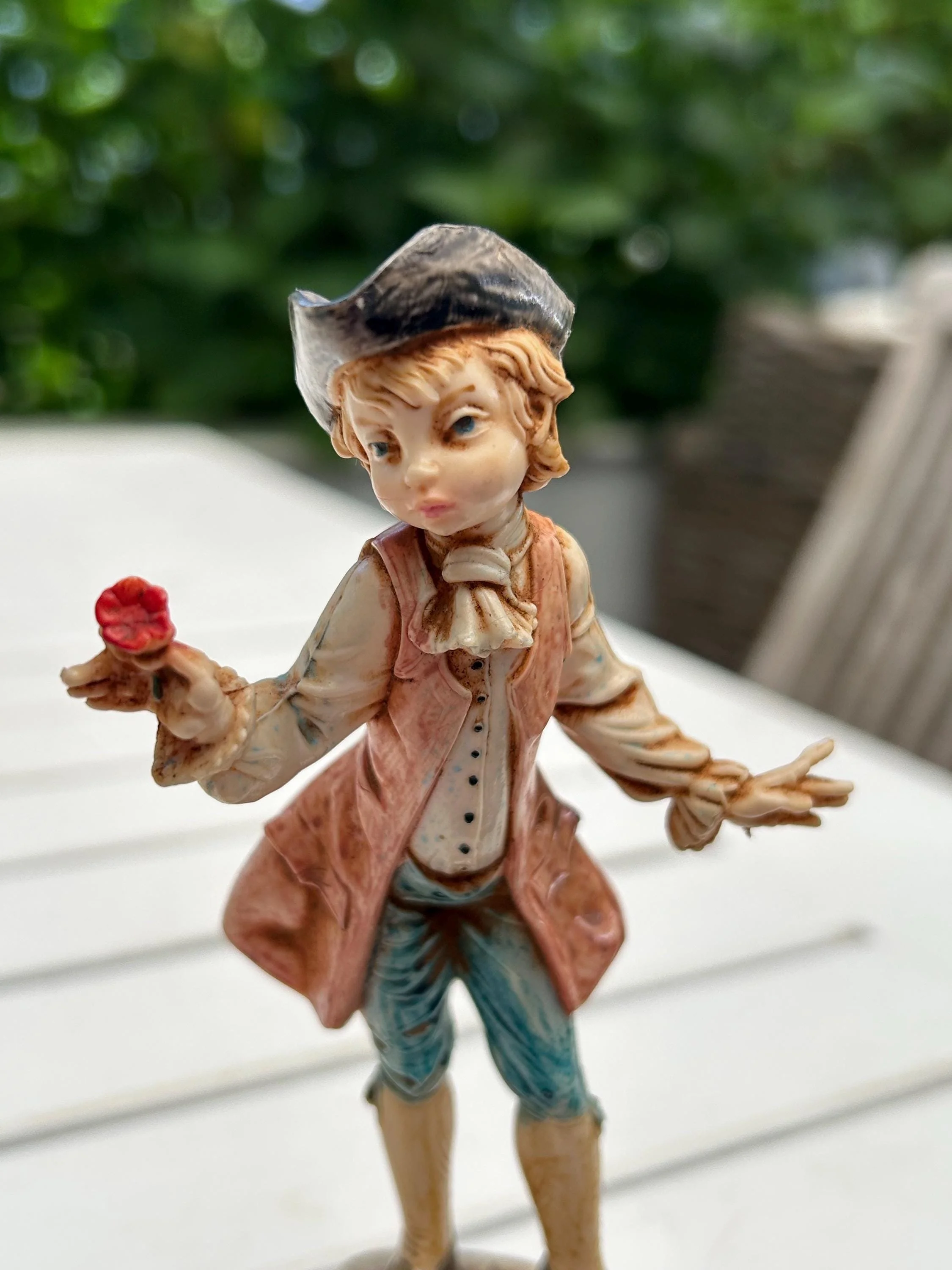 Close-up of boy’s expressive face and flower