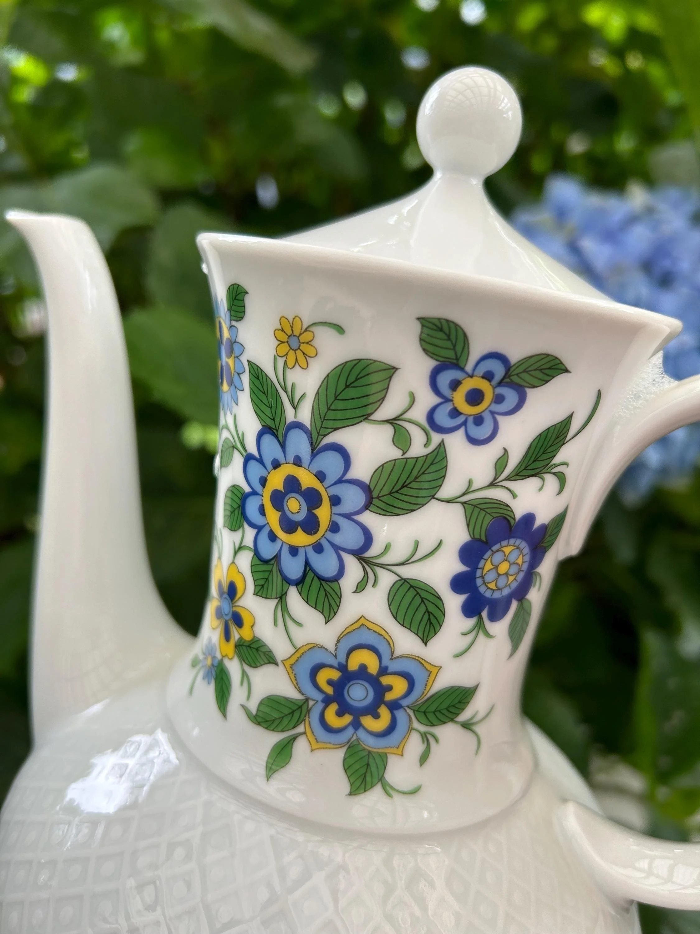 Close-up of floral pattern with blue, yellow, and green flowers