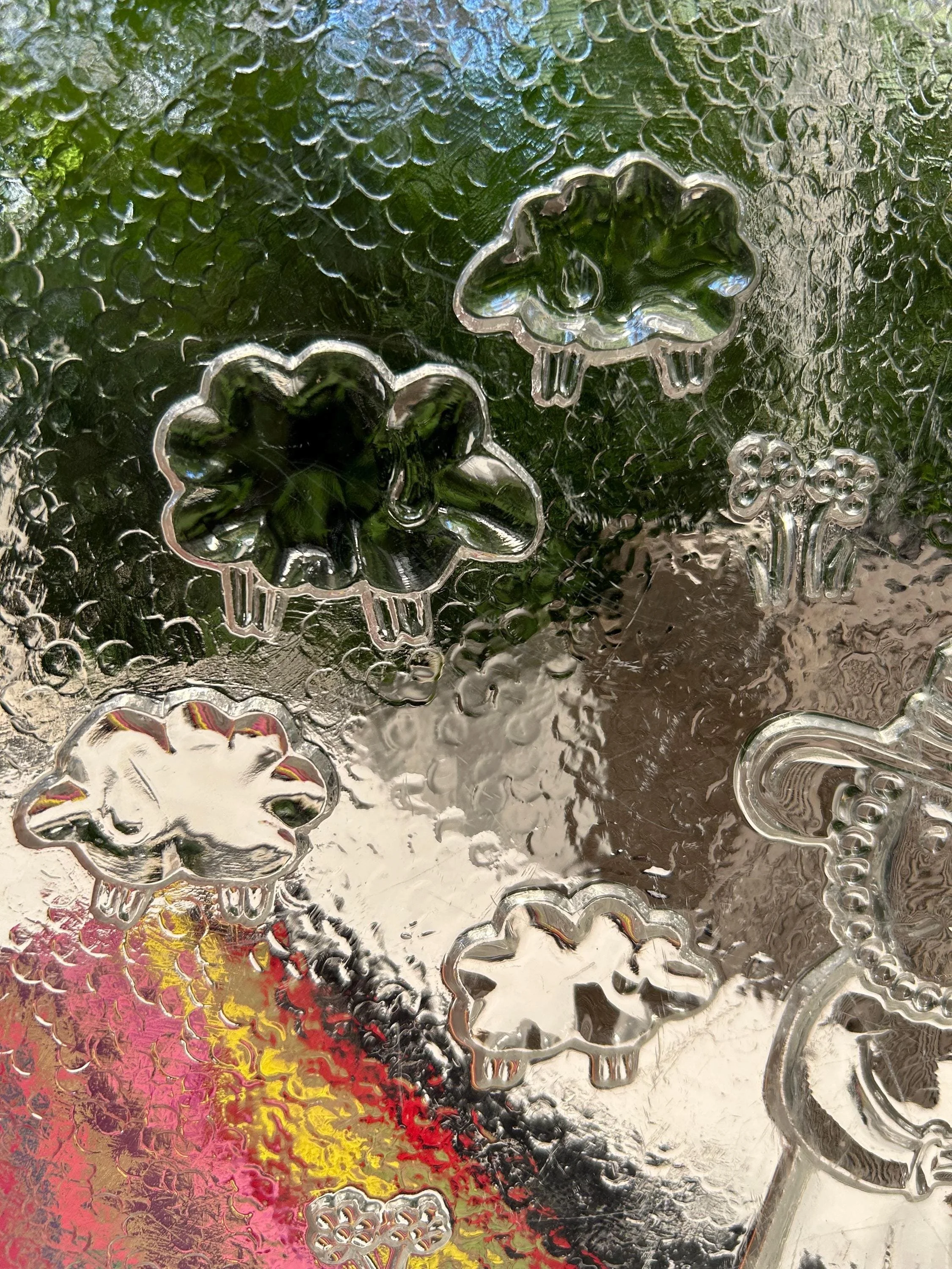 Detailed view of embossed sheep and flower motifs