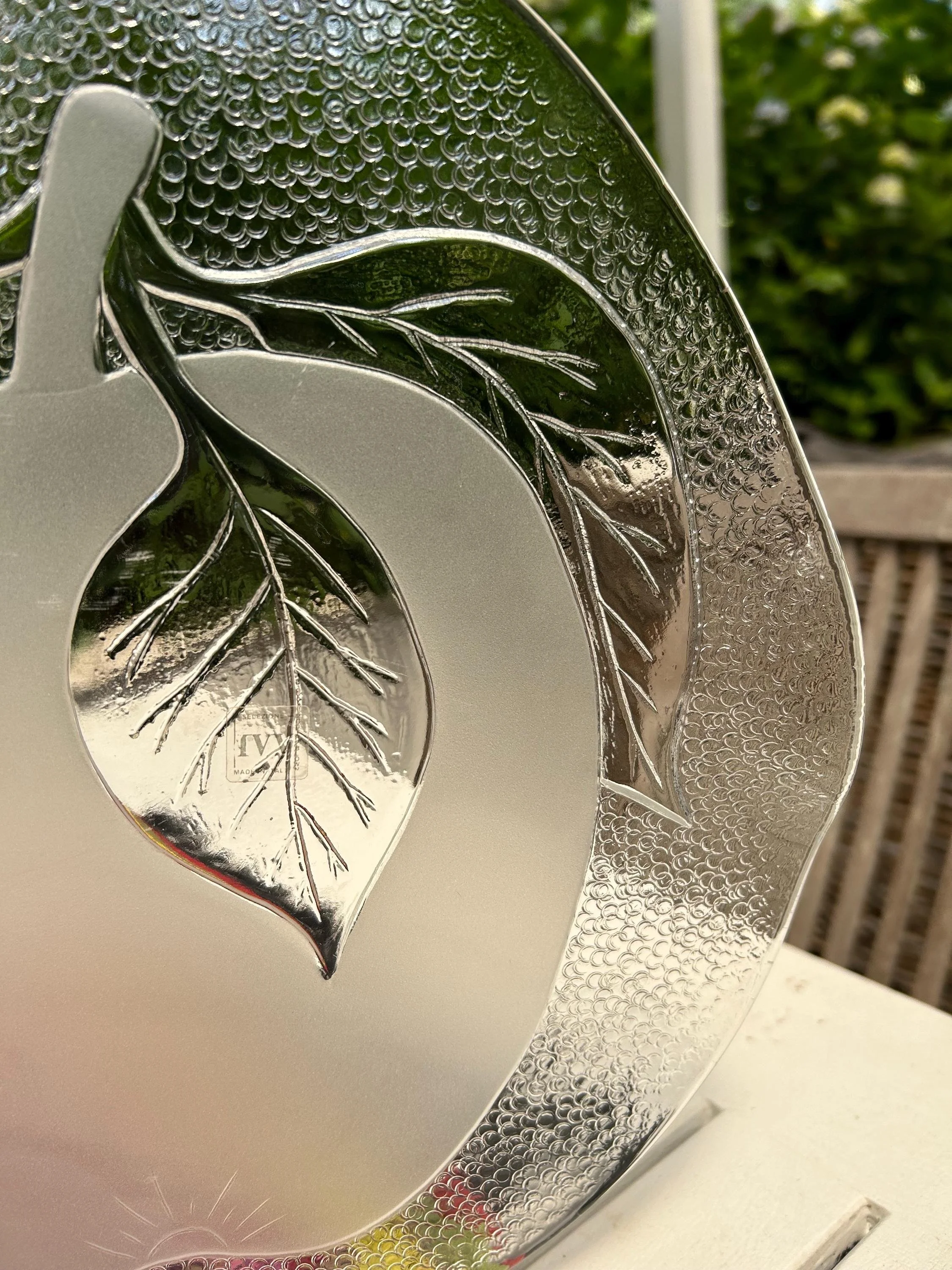 Close-up of textured glass and frosted apple silhouette.