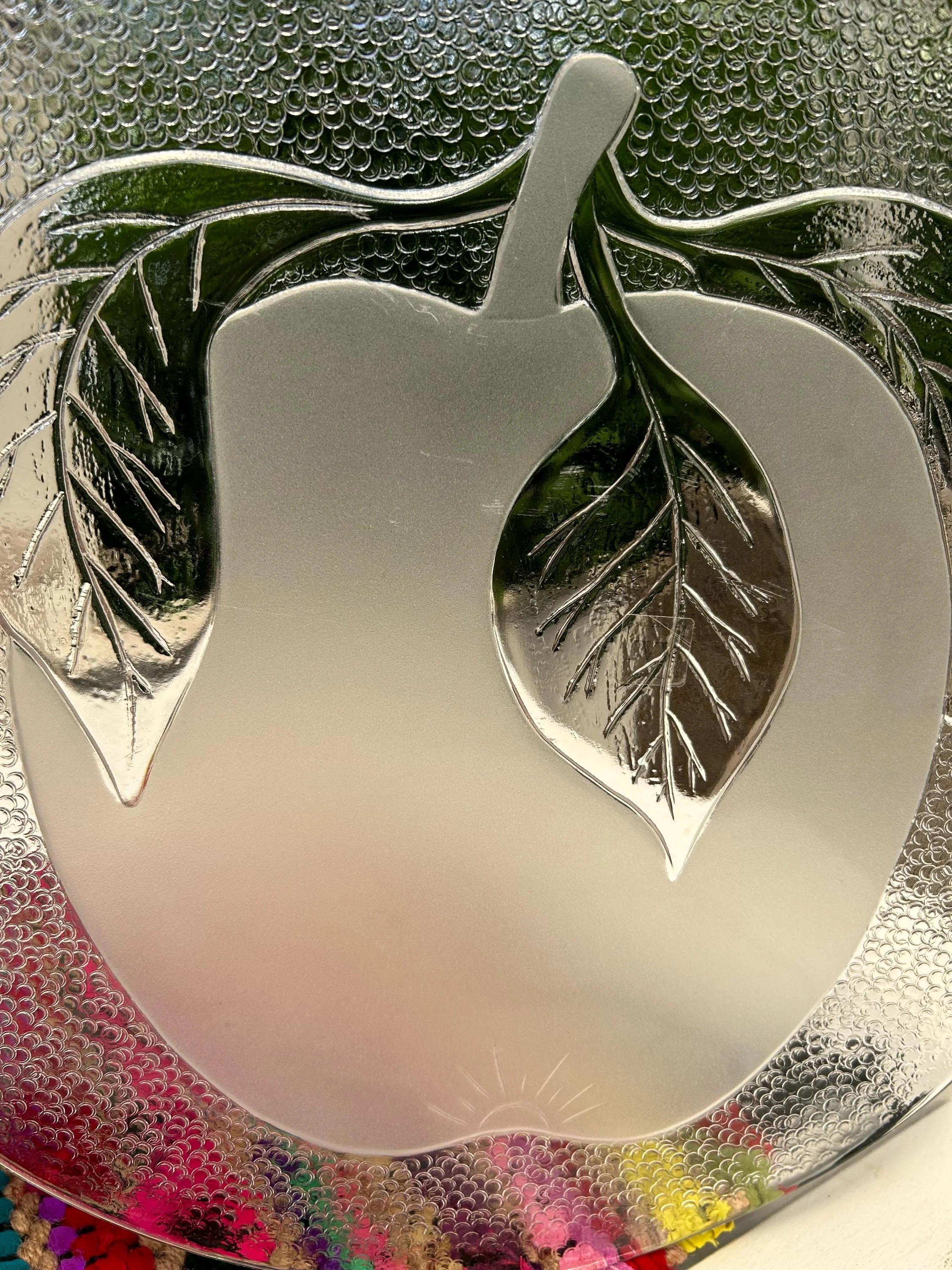 Detail of frosted apple and leaf motif.