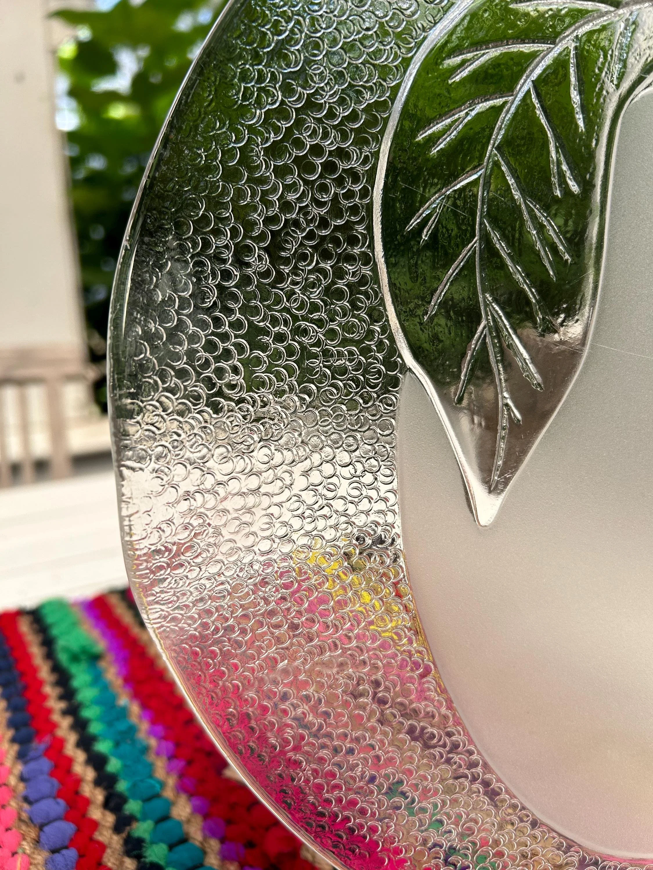 Edge view showing textured hammered effect and leaf detail.