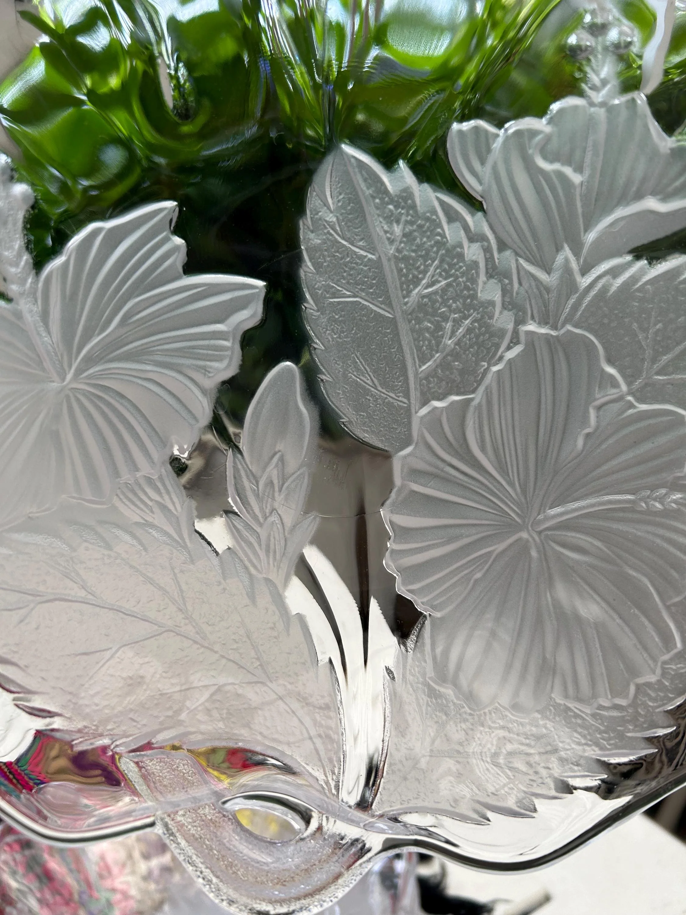 Underside view highlighting frosted floral detailing.