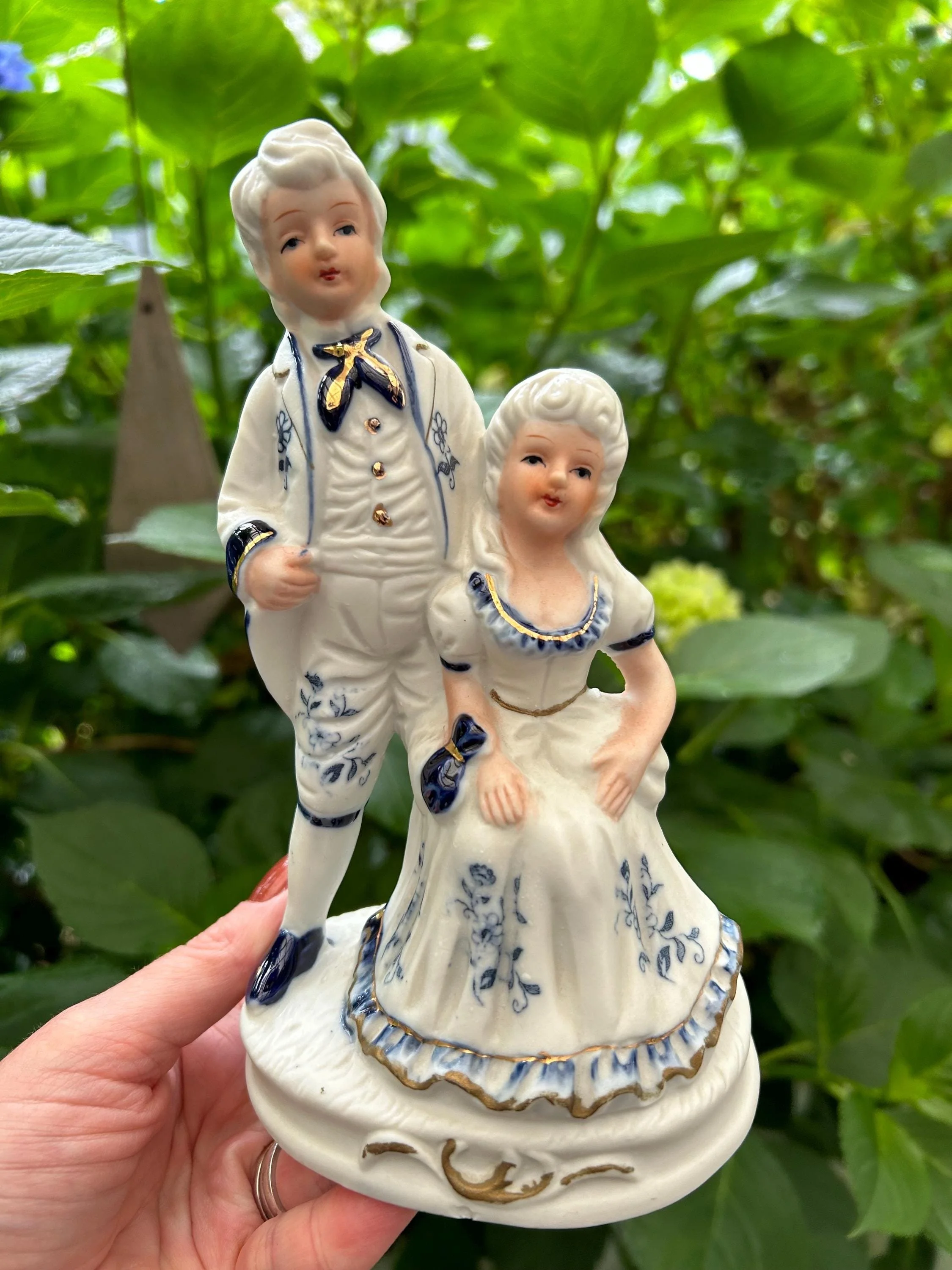 Elegant biscuit porcelain figurine of a Baroque couple with blue and gold detailing. Vintage decor ideal for romantic or Rococo-inspired interiors.