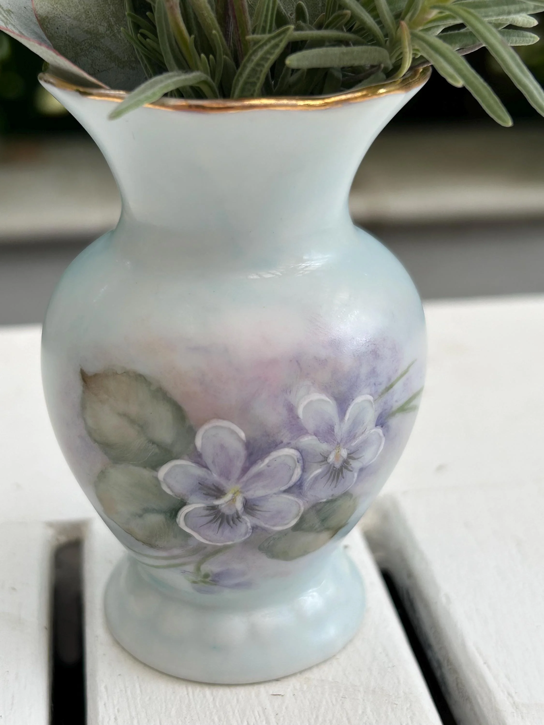 Side angle showing floral design and lavender bouquet against outdoor background