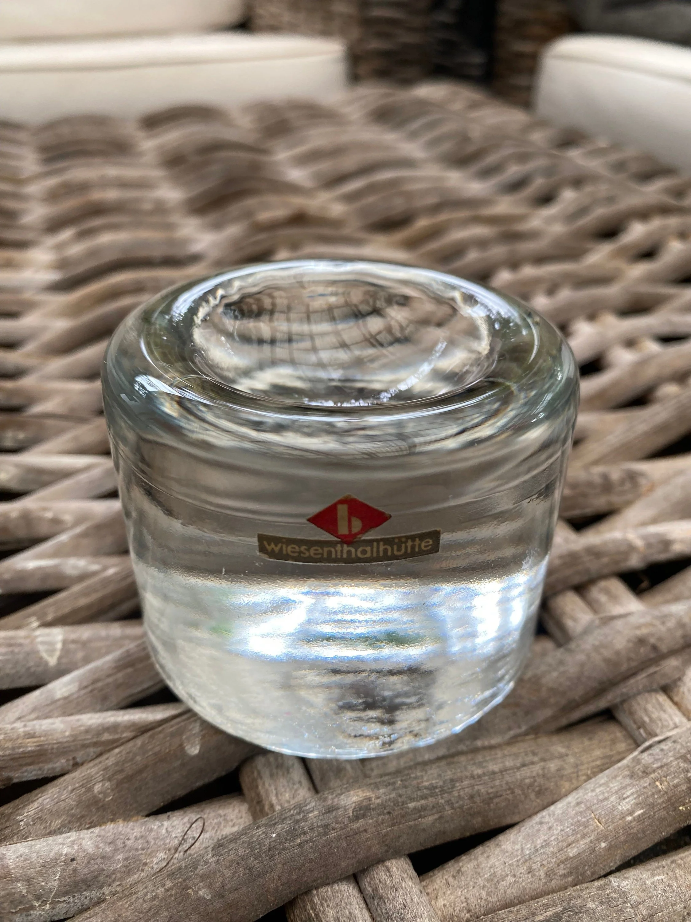 Front view of the candle holder highlighting the thick glass base and maker’s sticker