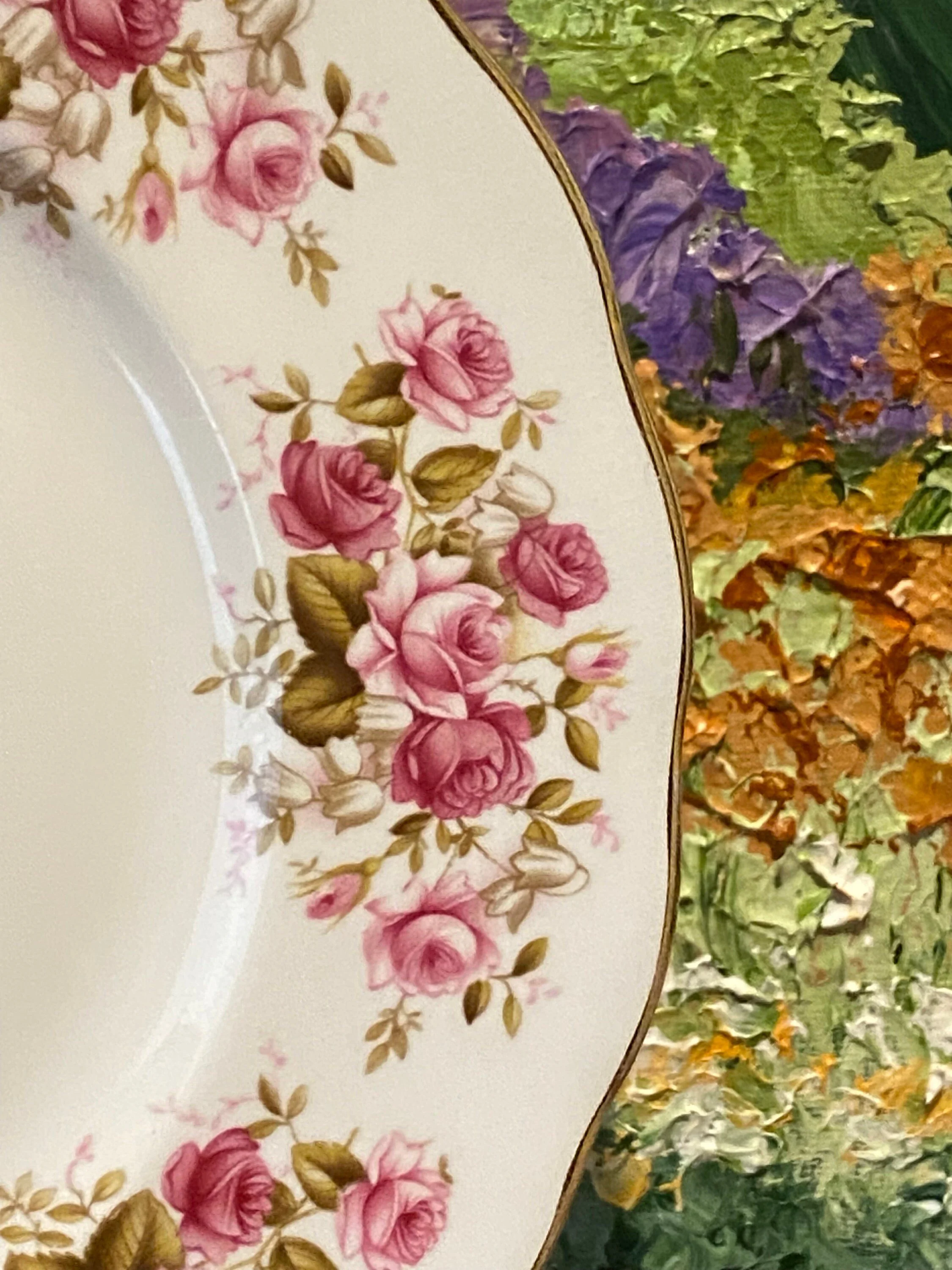 Close-up of pink roses against vibrant painting backdrop