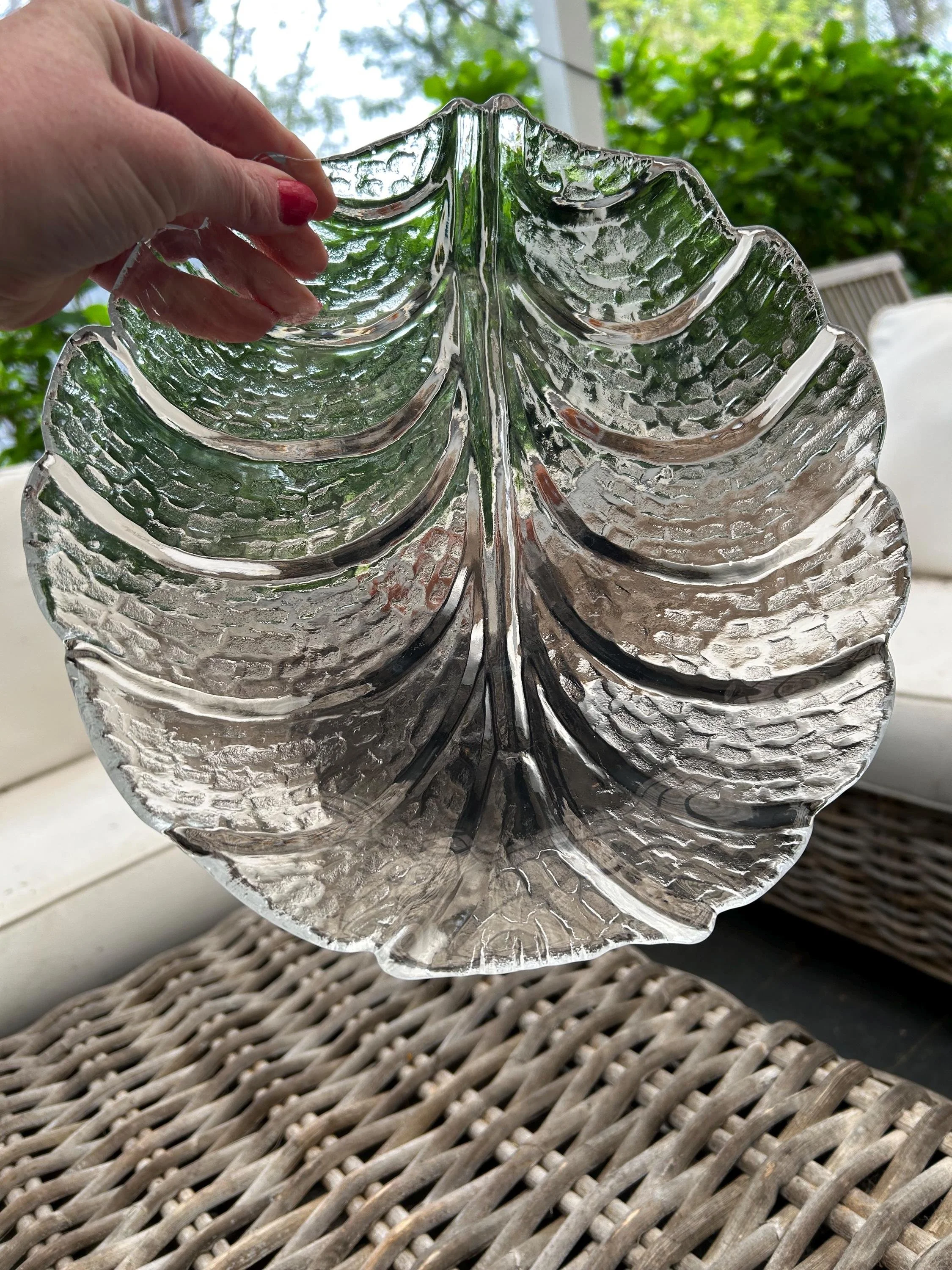 Plate held upright, highlighting clear embossing and raised rim