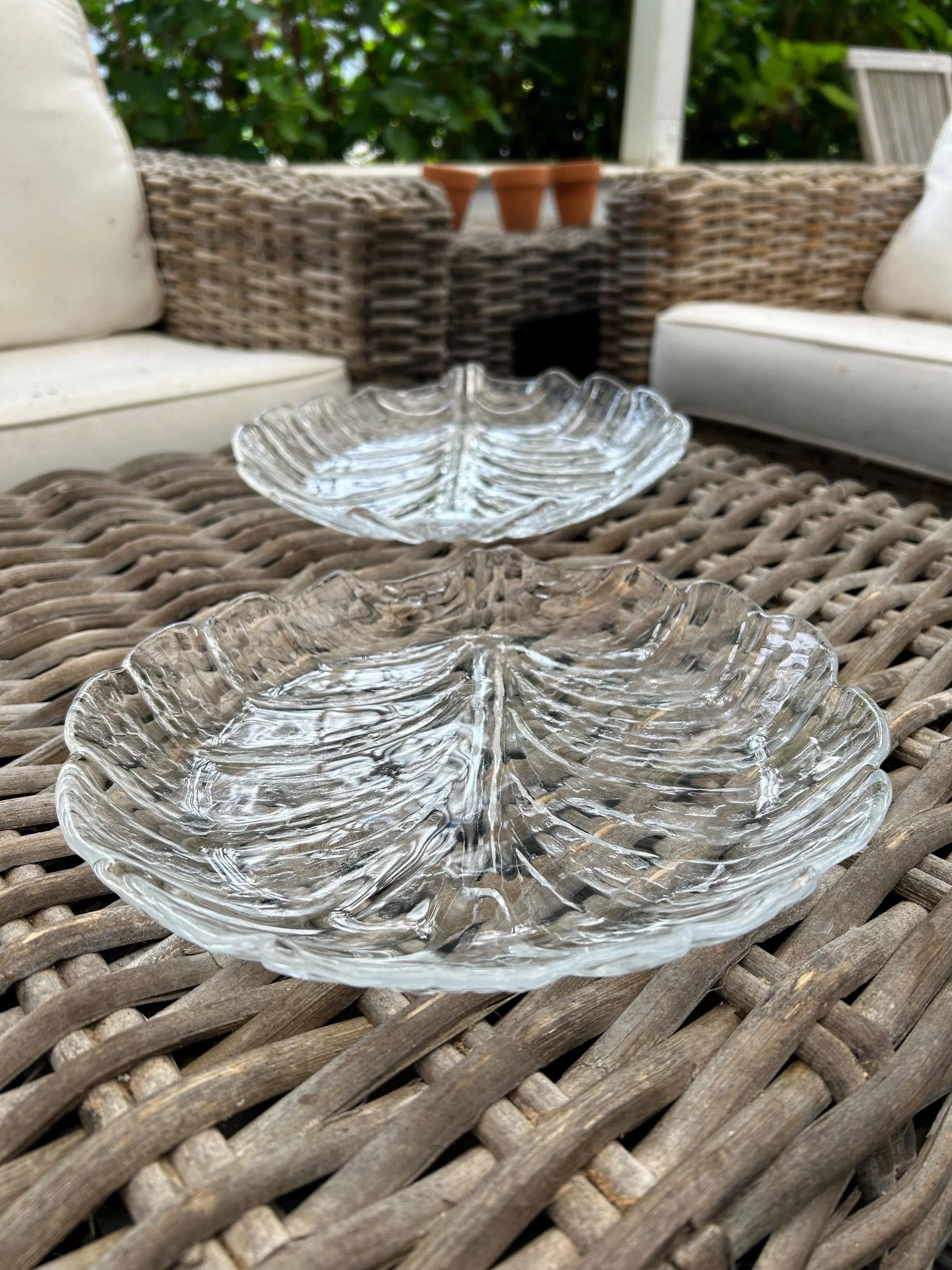 Pair of Orrefors serving plates on wicker background, side by side