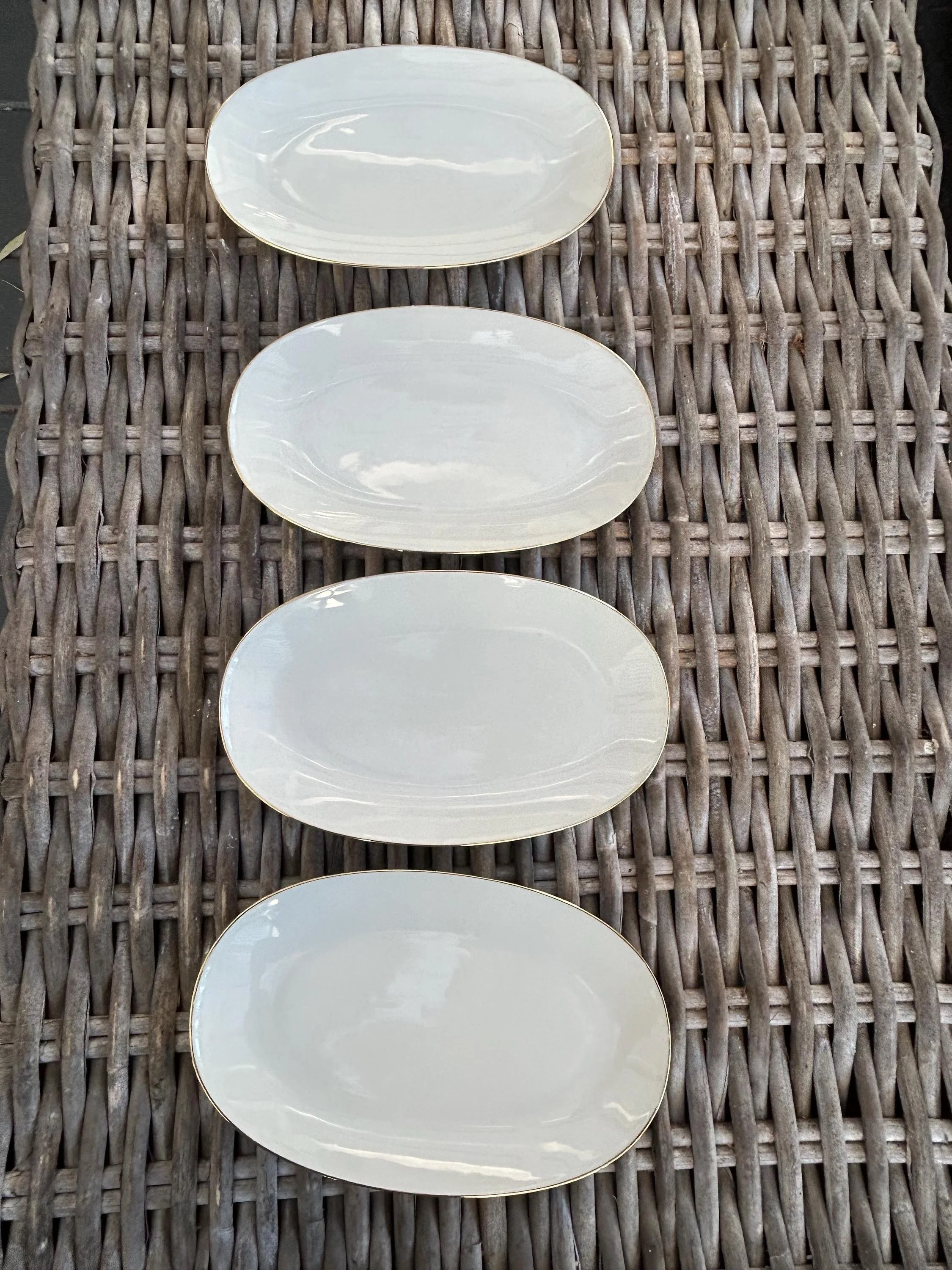 plates arranged vertically on woven background.