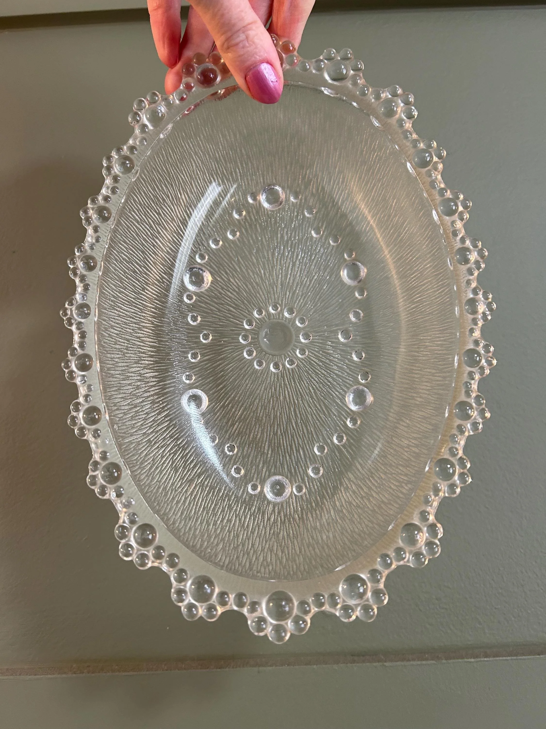 Masserini Barocco oval glass dish held to show bubble edge and textured design