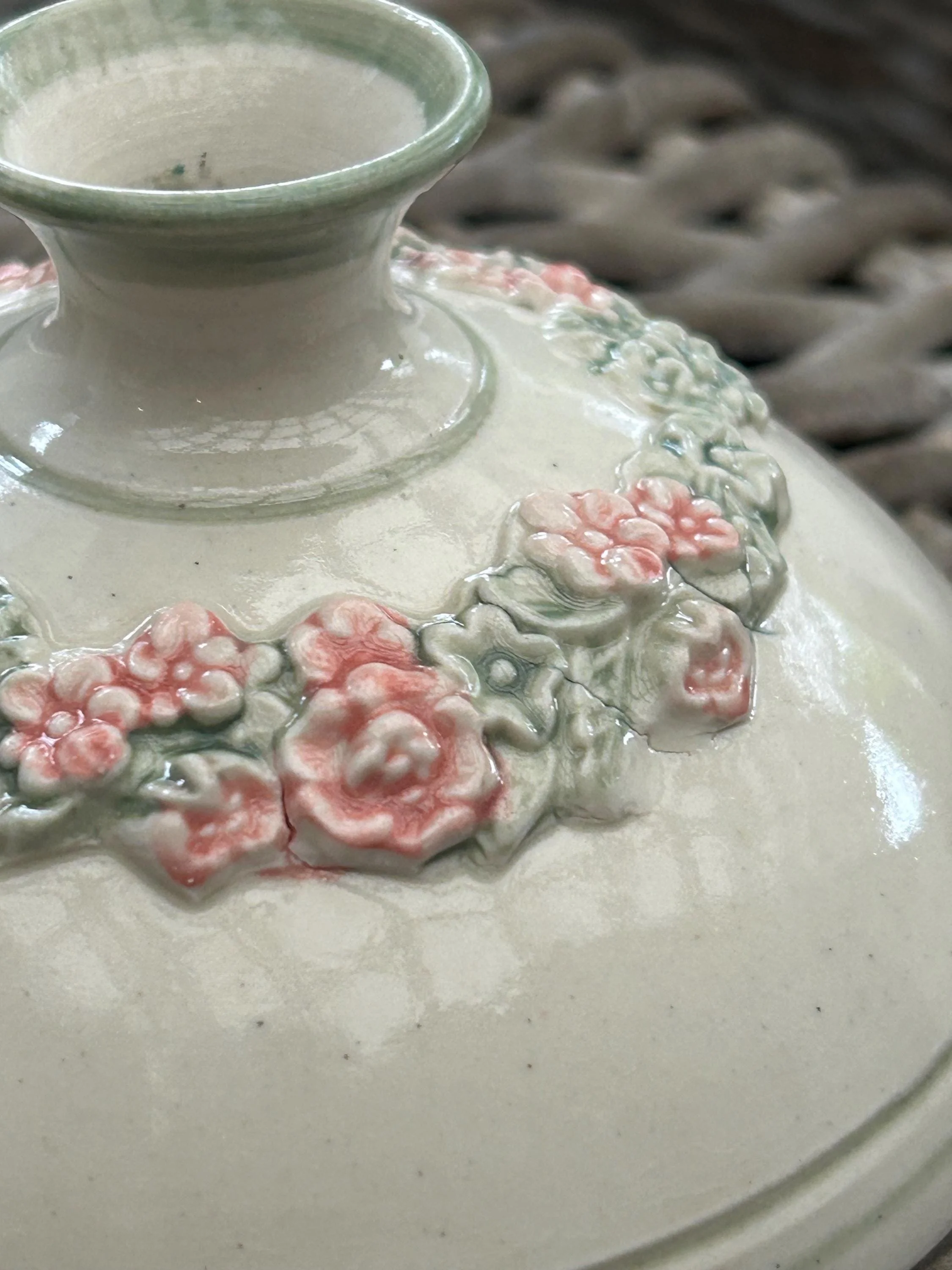 Detail of candle holder opening and hand-painted flower motif