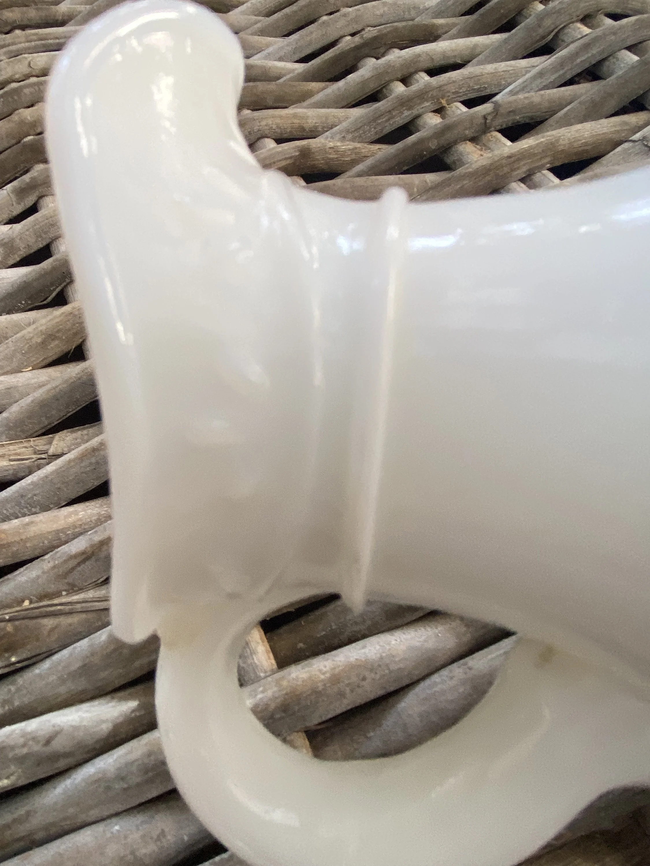 Close-up of spout detail and milk glass texture