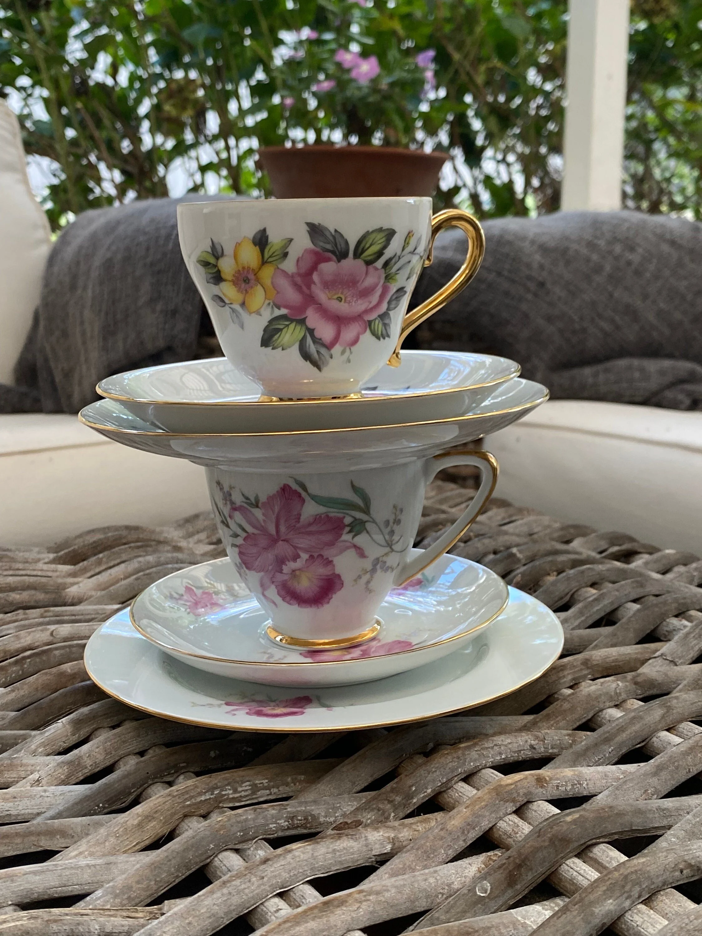 Stacked display of both Westminster trios showing the layered plates, saucers and floral cups together