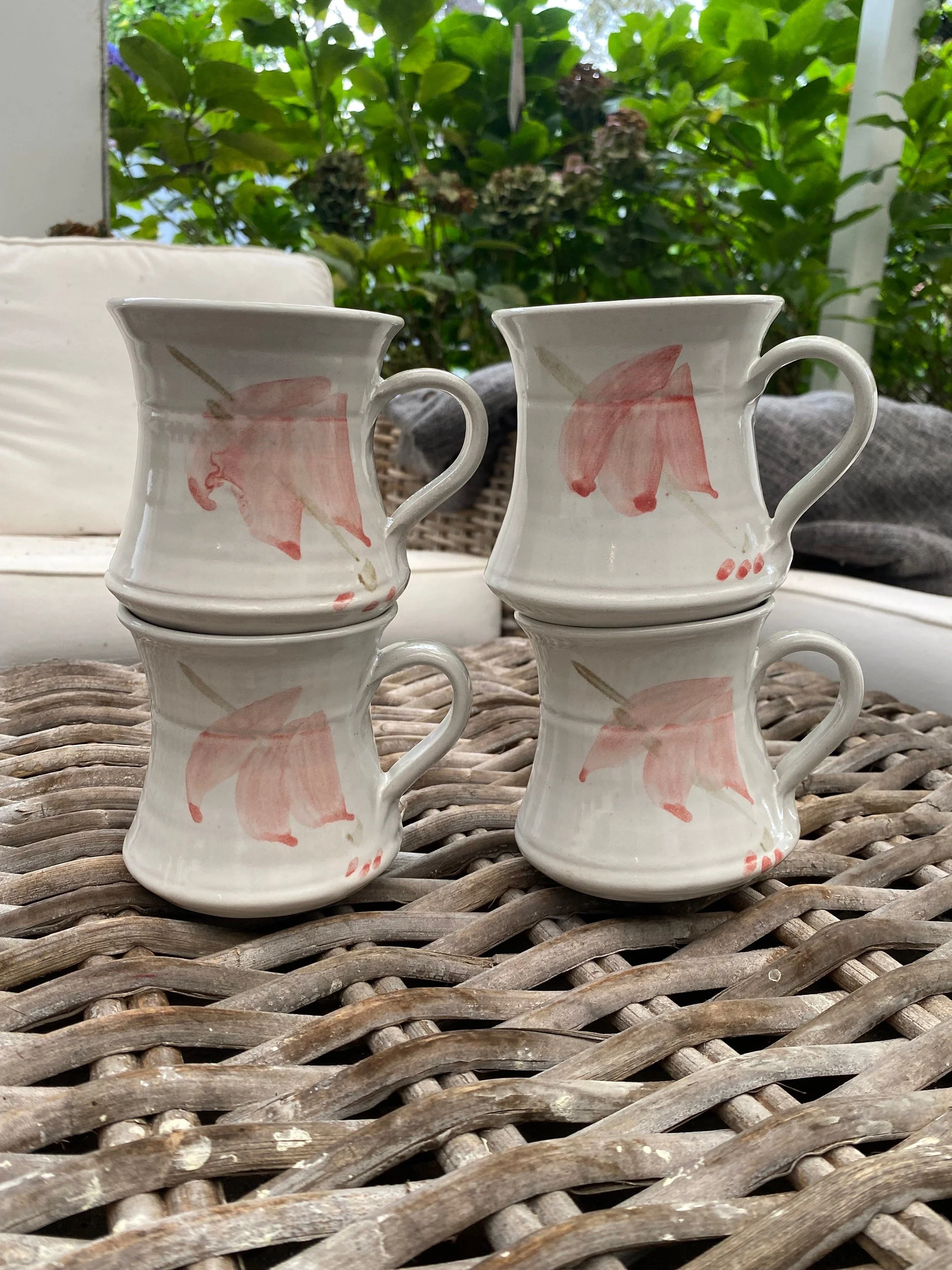 Set of 4 Australian handmade ceramic mugs with hand-painted peach floral motifs. Cream glaze with artisan charm—perfect for tea, coffee, or gifting.