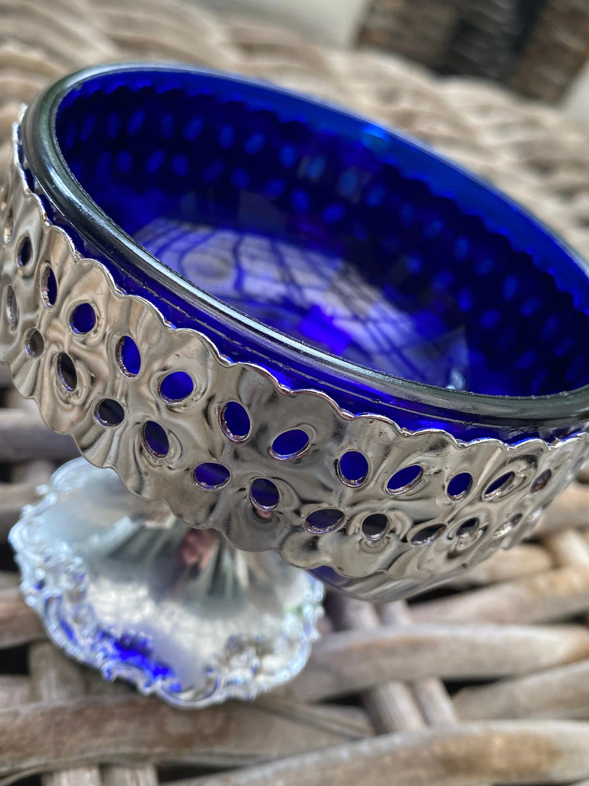 Angled close-up showing openwork detail and blue glass glow