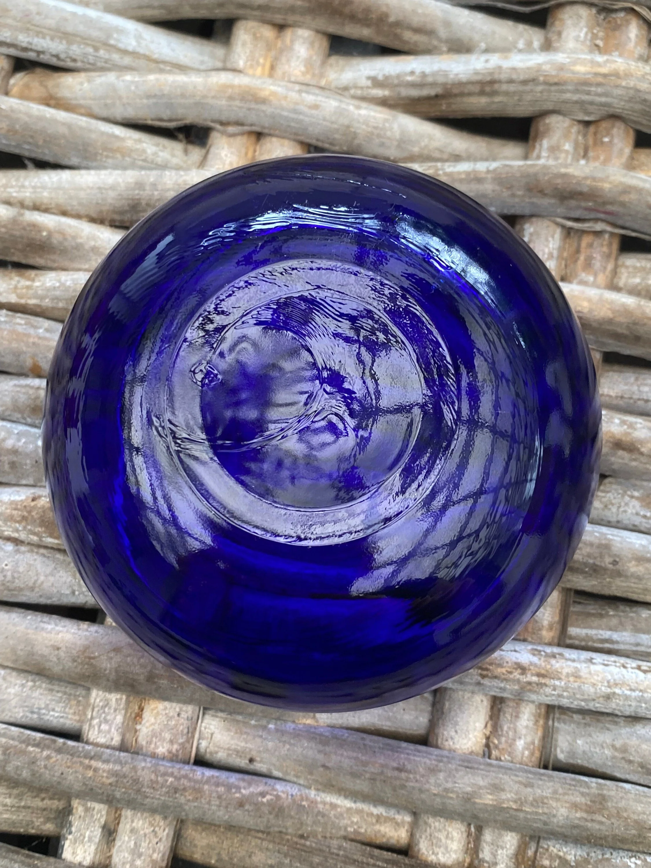 Underside of cobalt glass insert showing swirl pattern