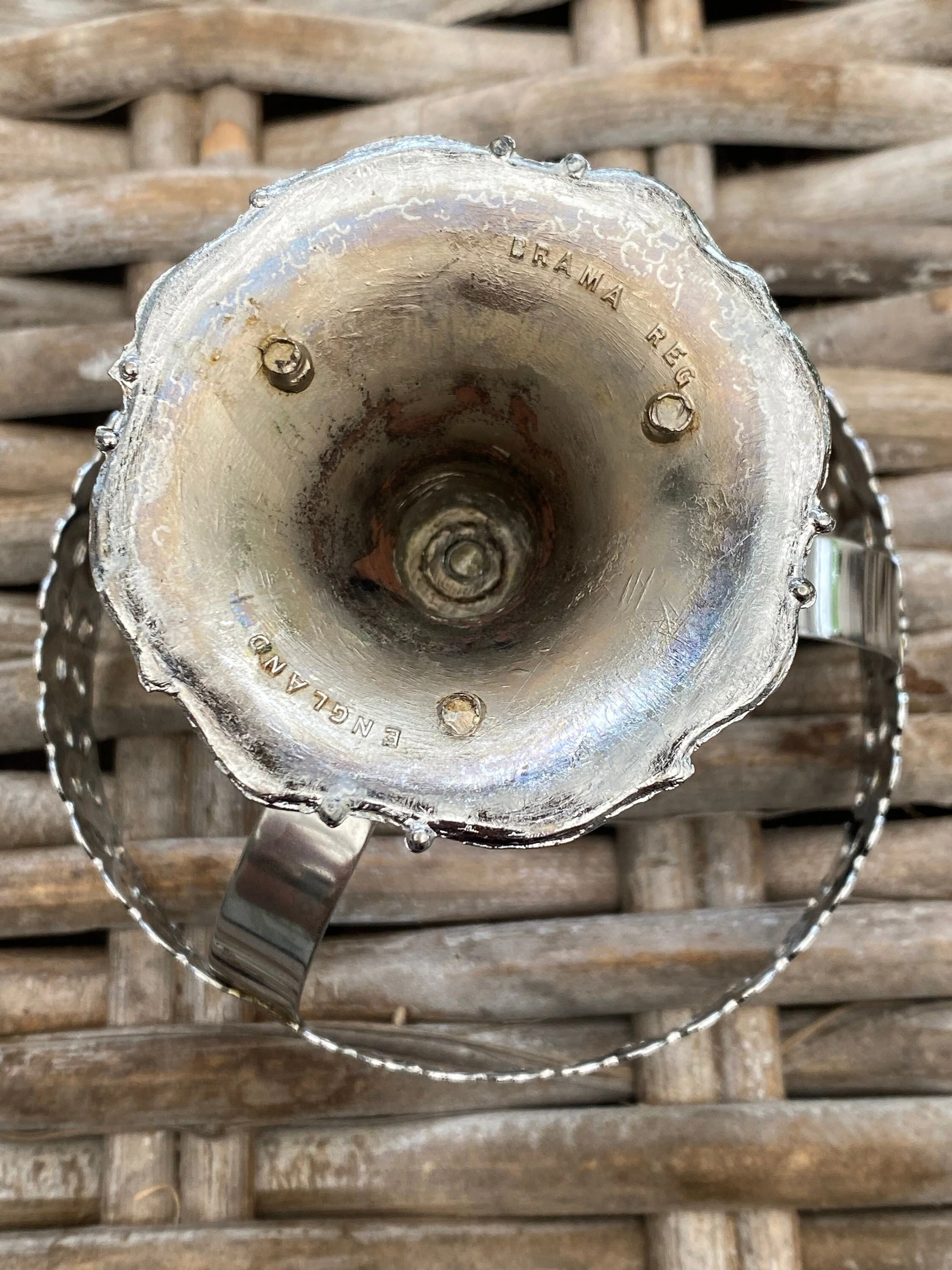 Underside of pedestal marked “ENGLAND” with patina visible