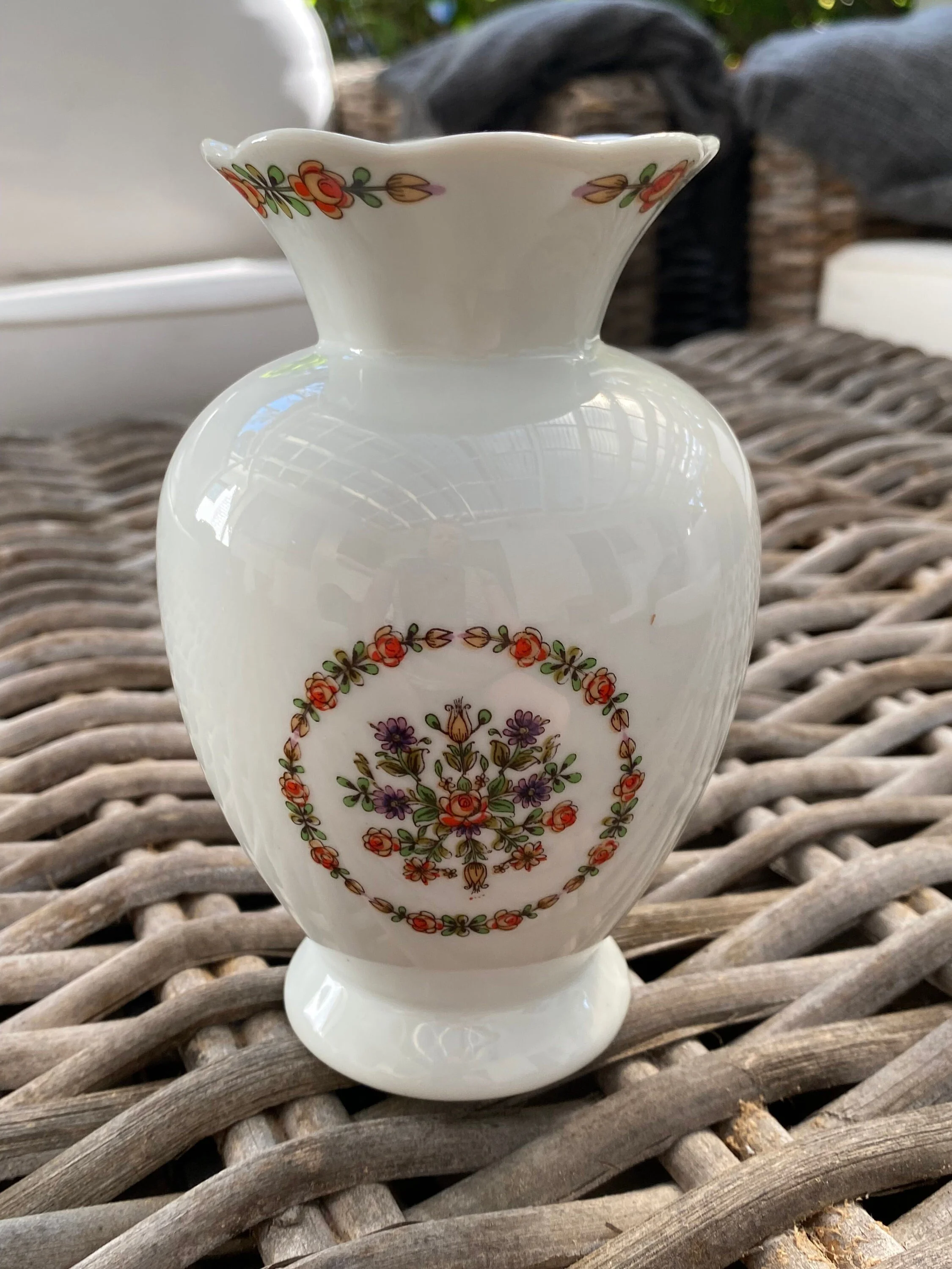 Close-up of the vase showing central floral medallion and glossy finish
