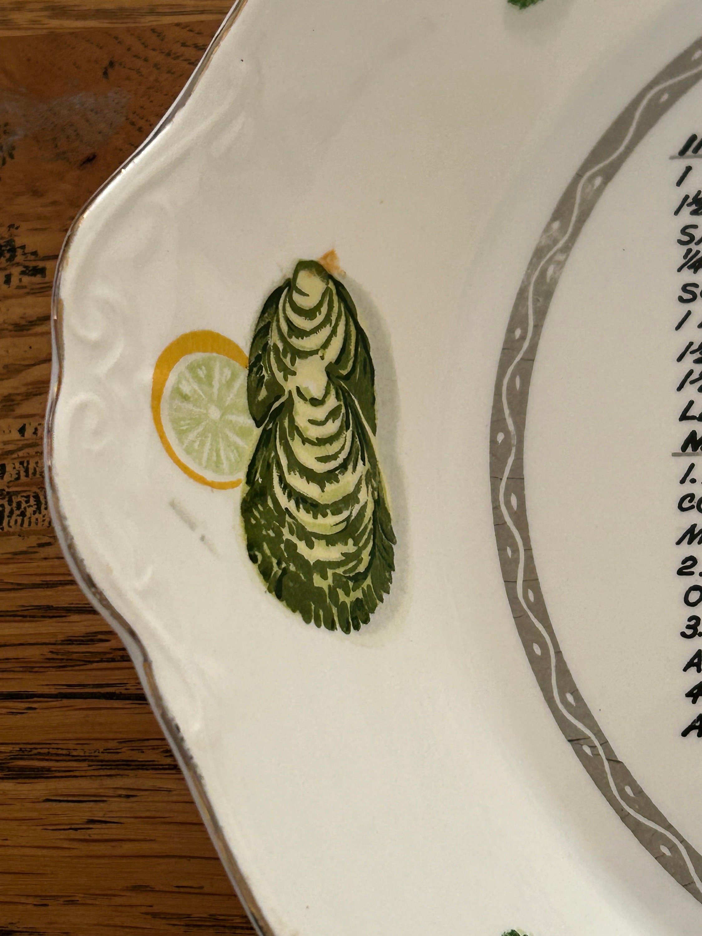 Side handle detail featuring hand-painted oyster and lemon slice