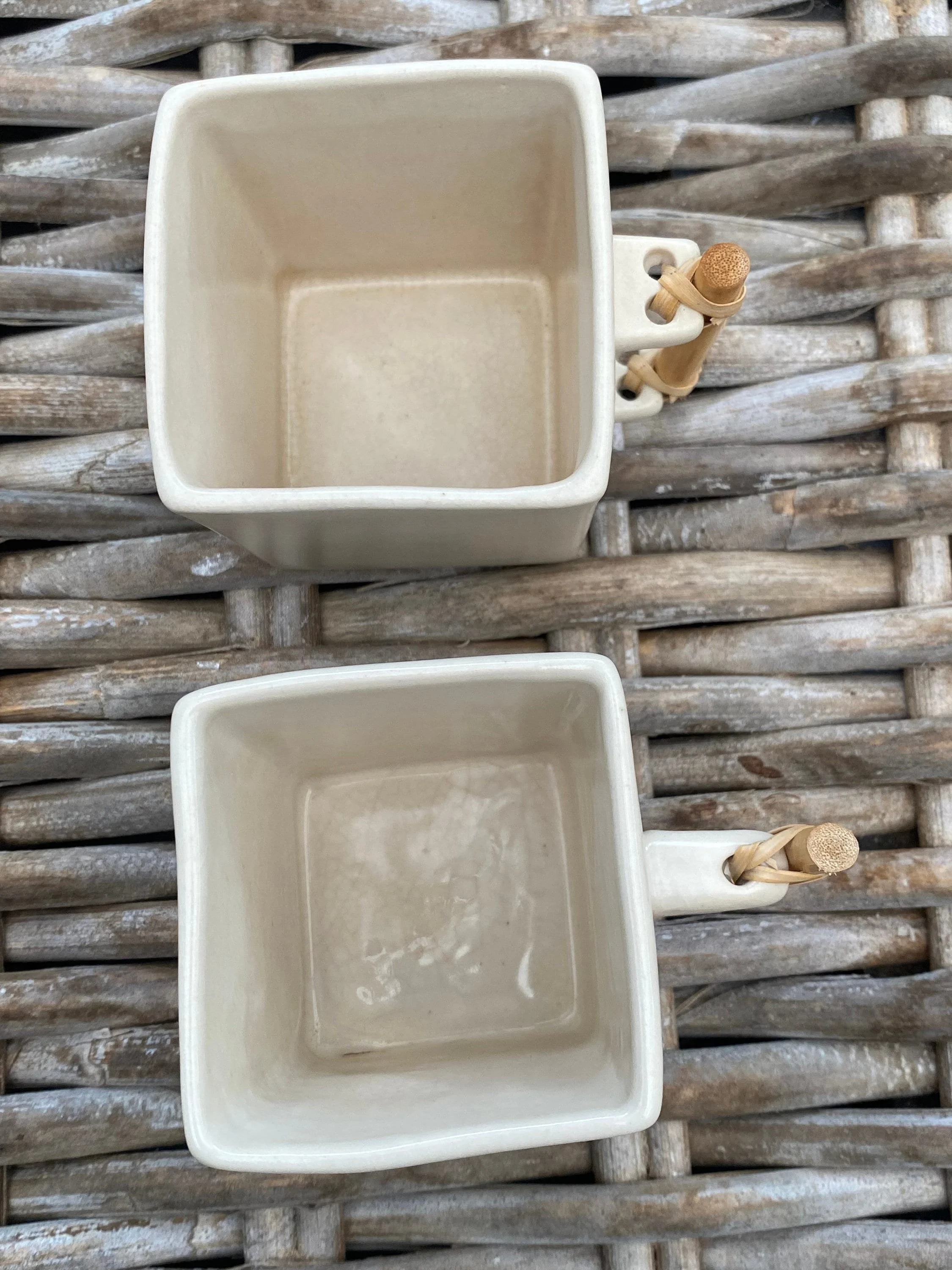 Top-down view into cream cups, showing interior glaze and square form