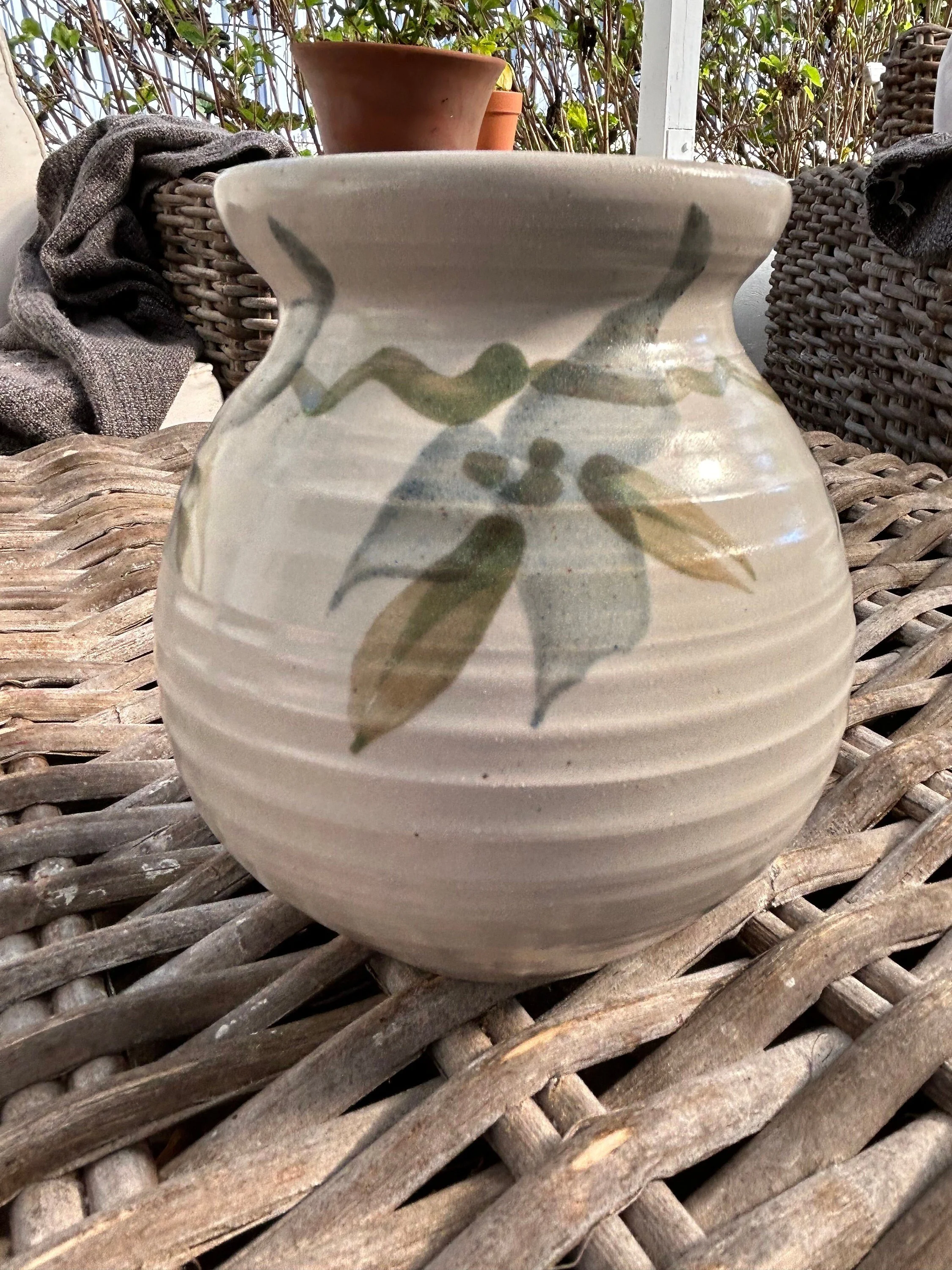 Back view of vase with botanical motif extending around