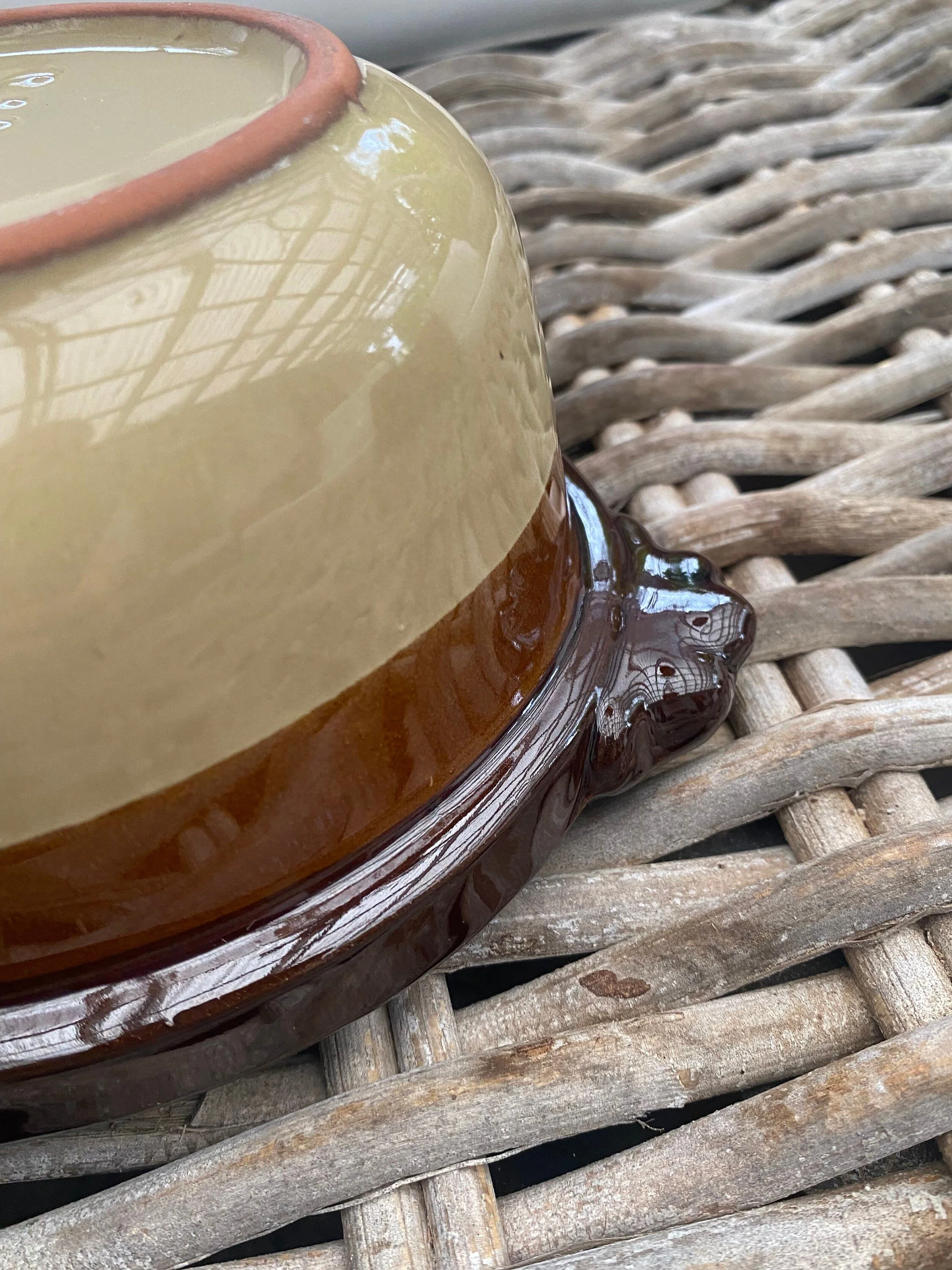 Close-up of the lower body showing the cream base, brown band, and handle attachment