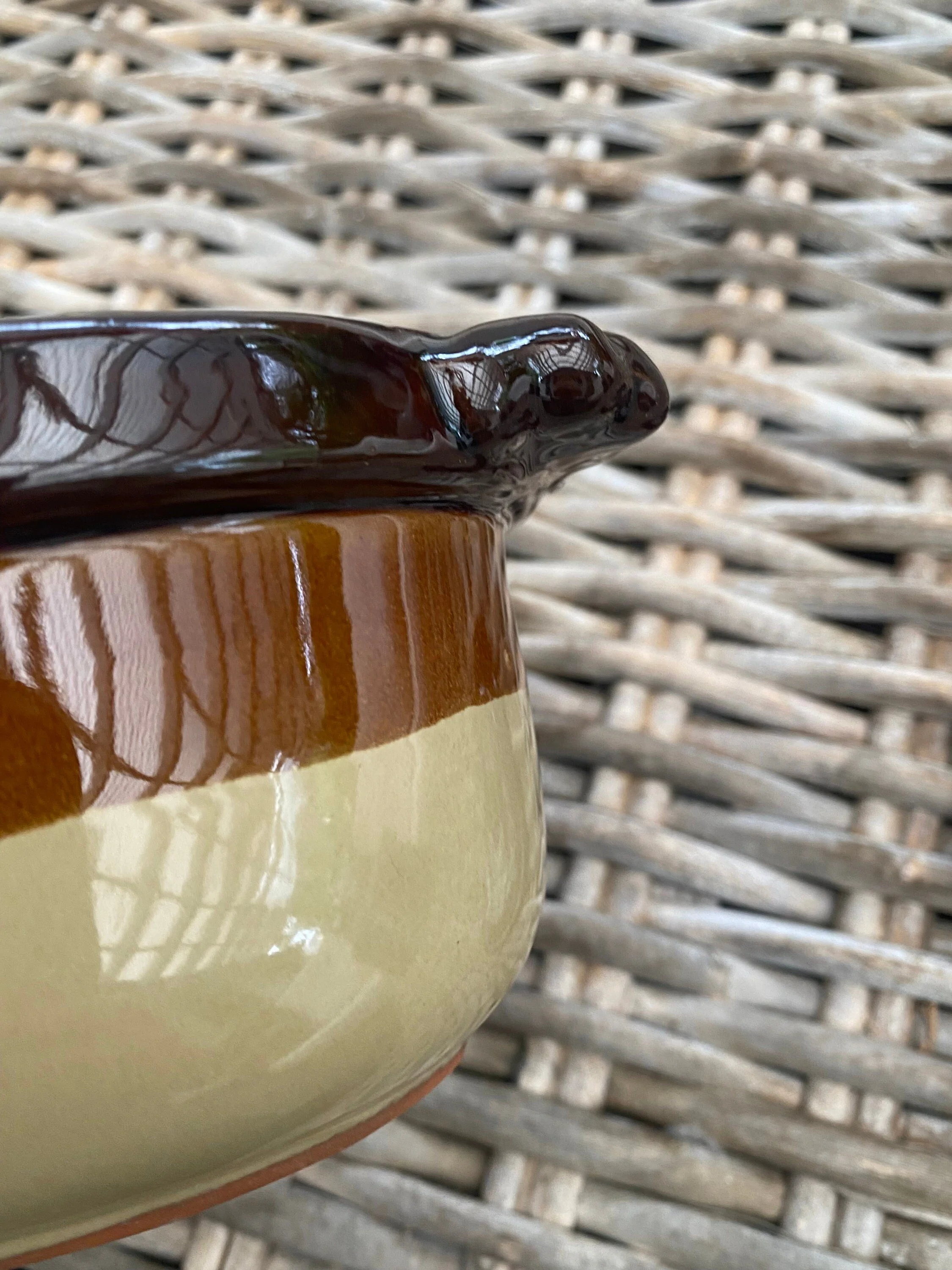 Close-up of the opposite side handle with brown glaze and cream body contrast