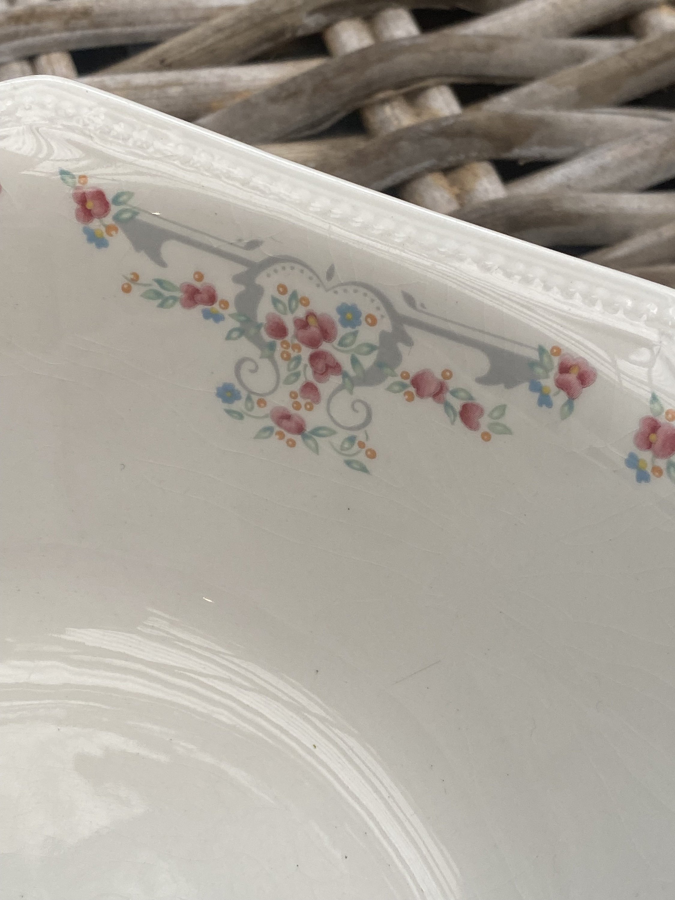 Side view highlighting floral motif and beaded rim detailing