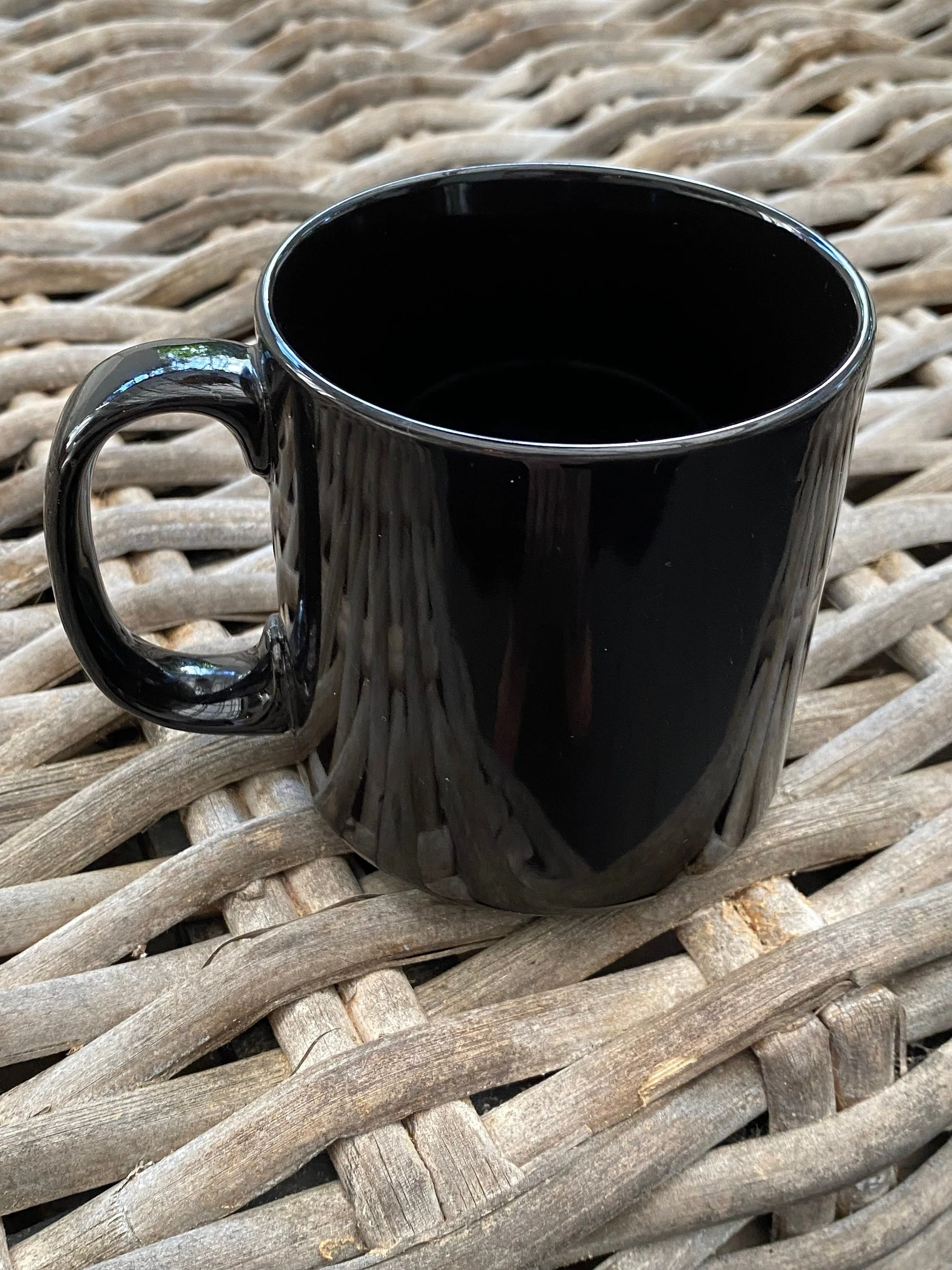 Side view showing the mug’s smooth handle and ribbed glossy finish