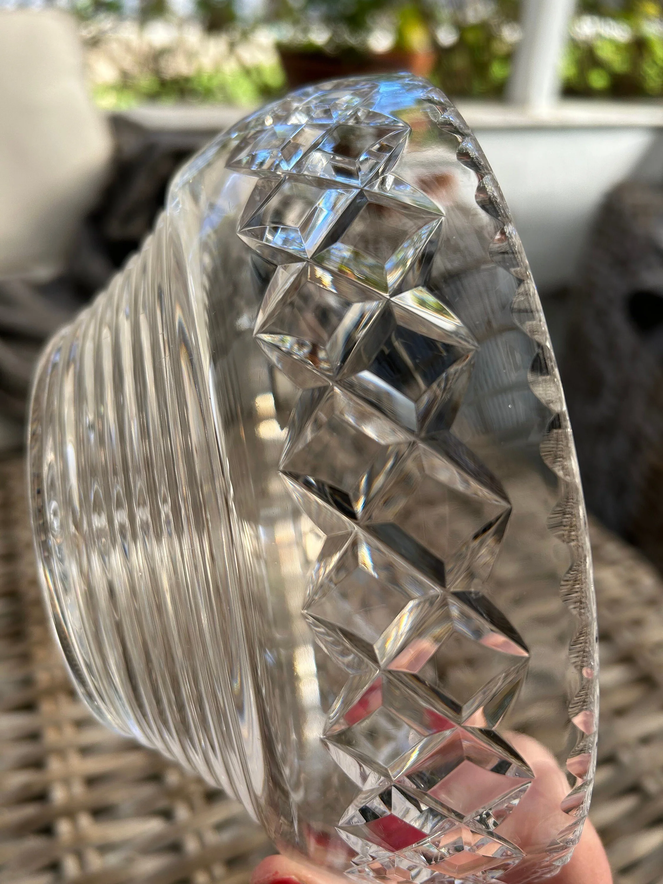 Close side angle of bowl highlighting diamond-cut rim and ribbed crystal body