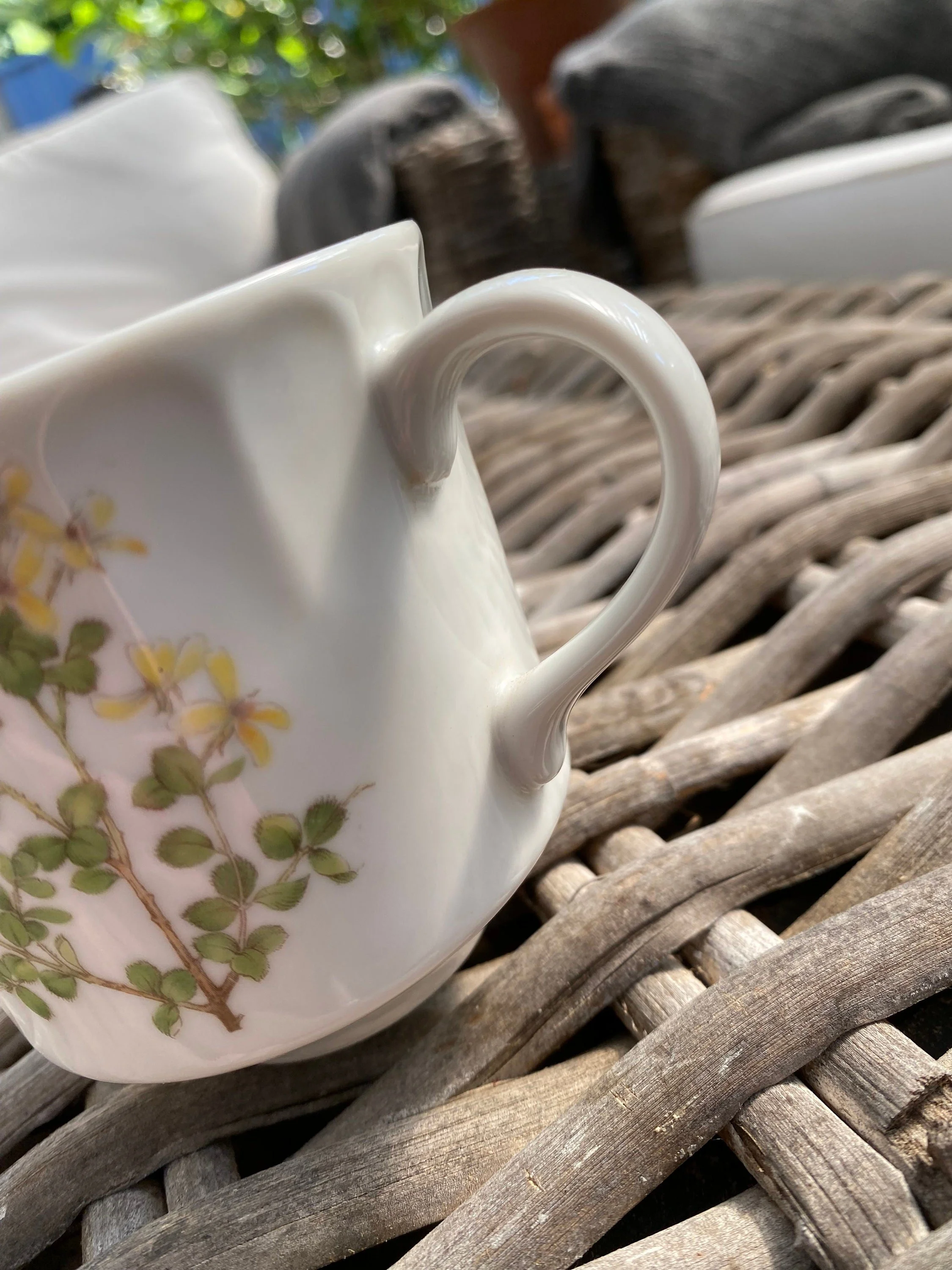 Close-up of handle and upper rim detail on vintage floral ceramic cup