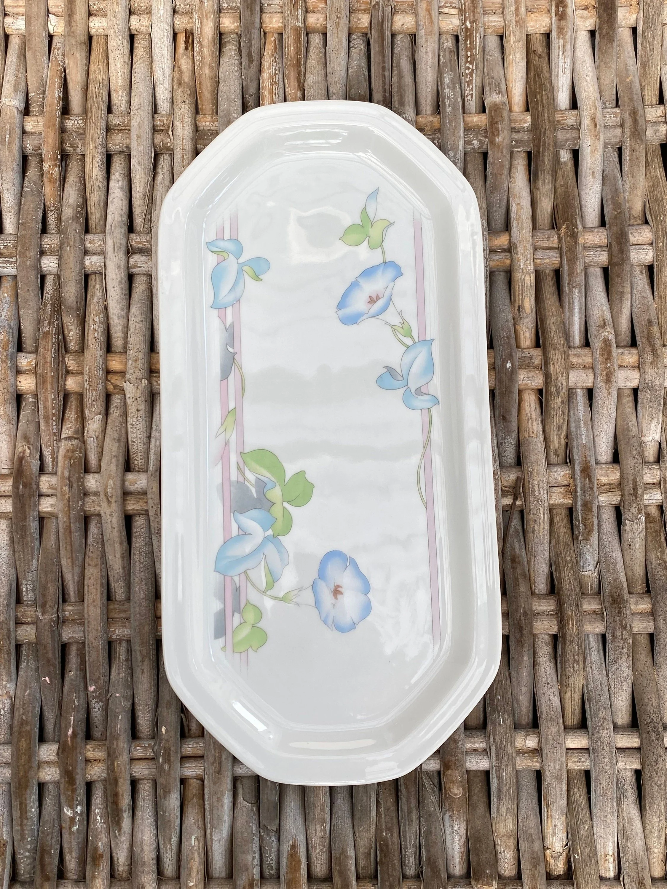 Full overhead view of the elongated platter showing its shape and balanced floral decoration